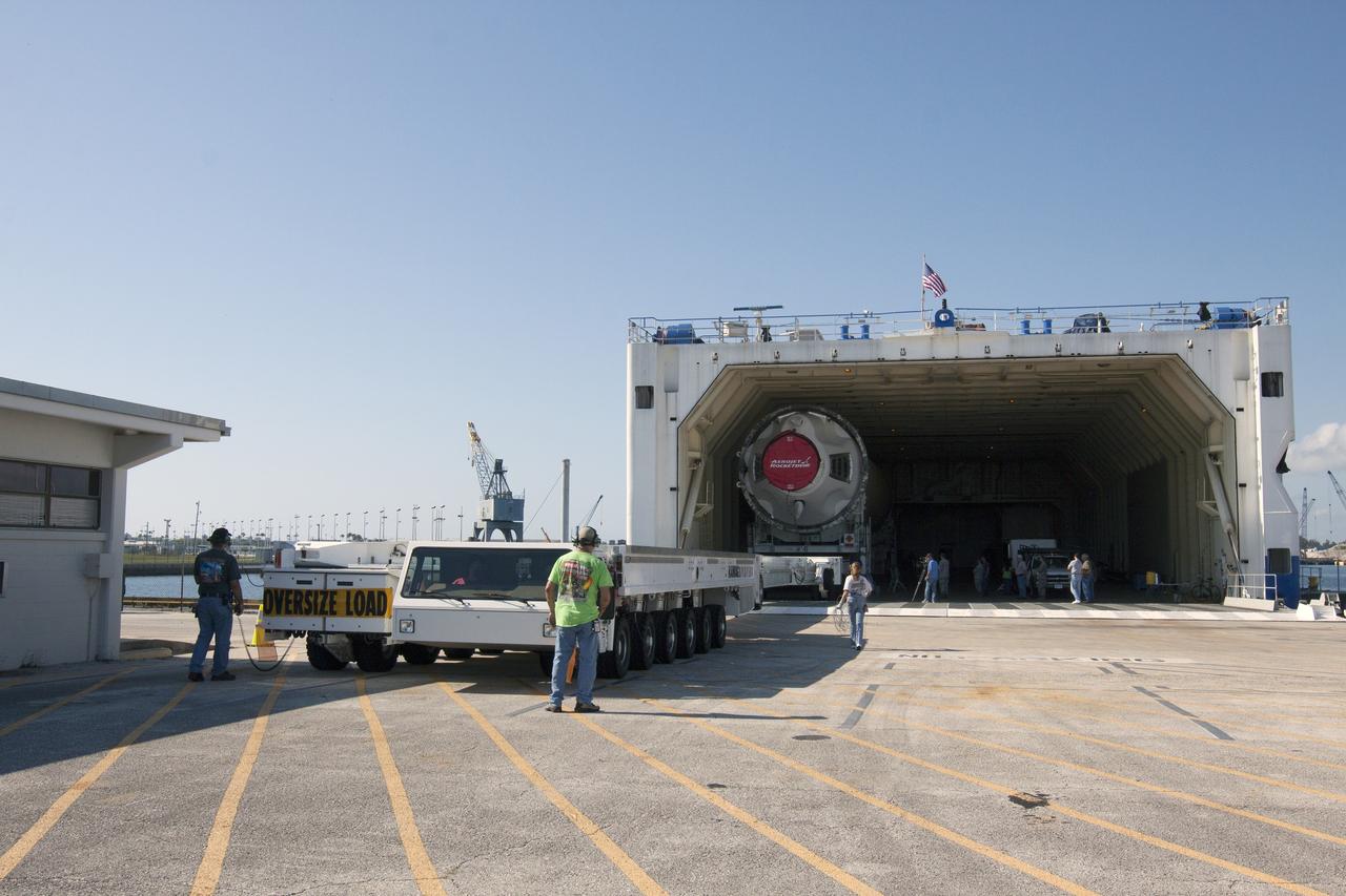 CAPE CANAVERAL, Fla. -- The port booster for the United Launch Alliance Delta IV Heavy for Exploration Flight Test-1, or EFT-1, is being offloaded from the barge at the U.S. Army Outpost wharf at Port Canaveral in Florida and will be transported to the Horizontal Integration Facility, or HIF, at Space Launch Complex 37 on Cape Canaveral Air Force Station. The upper stage and spacecraft adapter arrived with the booster and were transported to the HIF on May 6.    At the HIF, all three booster stages will be processed and checked out before being moved to the nearby launch pad and hoisted into position. The spacecraft adapter will connect Orion to the ULA Delta IV, and also will connect Orion to NASA's new rocket, the Space Launch System, on its first mission in 2017. During the EFT-1 mission, Orion will travel farther into space than any human spacecraft has gone in more than 40 years. The data gathered during the flight will influence design decisions, validate existing computer models and innovative new approaches to space systems development, as well as reduce overall mission risks and costs for later Orion flights. Liftoff of Orion on EFT-1 is planned for fall 2014. Photo credit: NASA/Kim Shiflett