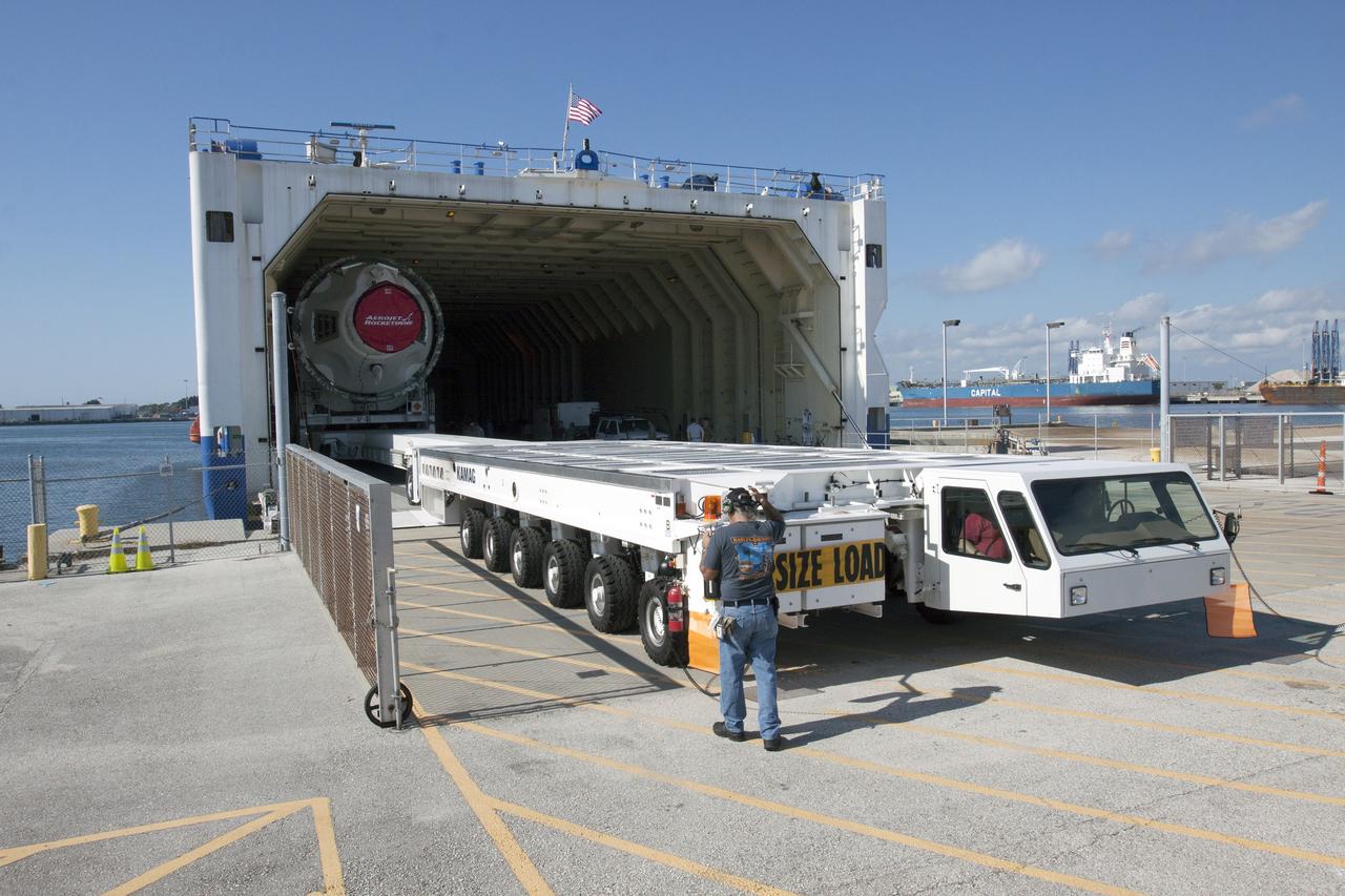 CAPE CANAVERAL, Fla. -- The port booster for the United Launch Alliance Delta IV Heavy for Exploration Flight Test-1, or EFT-1, is being offloaded from the barge at the U.S. Army Outpost wharf at Port Canaveral in Florida and will be transported to the Horizontal Integration Facility, or HIF, at Space Launch Complex 37 on Cape Canaveral Air Force Station. The upper stage and spacecraft adapter arrived with the booster and were transported to the HIF on May 6.    At the HIF, all three booster stages will be processed and checked out before being moved to the nearby launch pad and hoisted into position. The spacecraft adapter will connect Orion to the ULA Delta IV, and also will connect Orion to NASA's new rocket, the Space Launch System, on its first mission in 2017. During the EFT-1 mission, Orion will travel farther into space than any human spacecraft has gone in more than 40 years. The data gathered during the flight will influence design decisions, validate existing computer models and innovative new approaches to space systems development, as well as reduce overall mission risks and costs for later Orion flights. Liftoff of Orion on EFT-1 is planned for fall 2014. Photo credit: NASA/Kim Shiflett