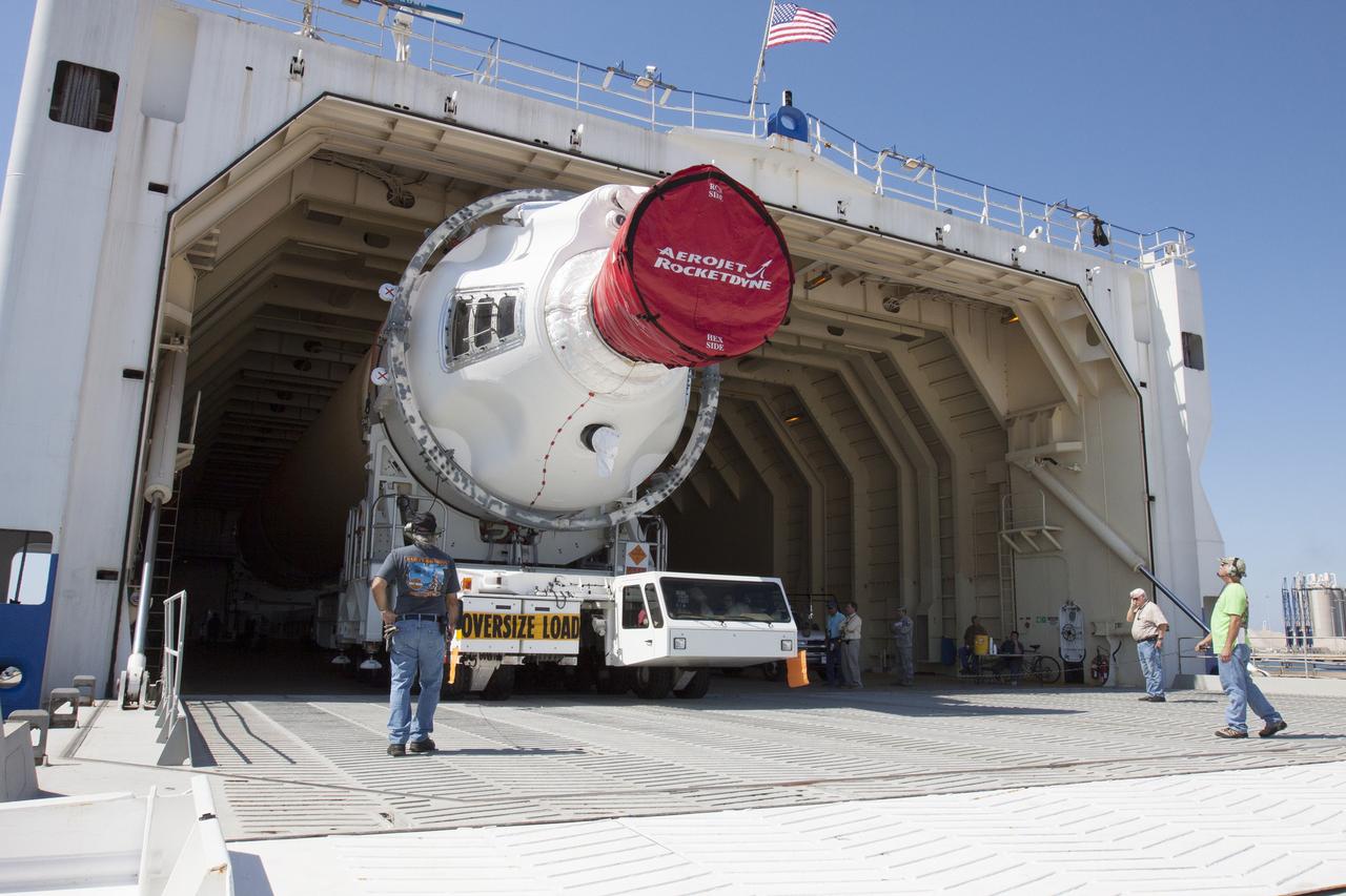 CAPE CANAVERAL, Fla. -- The port booster for the United Launch Alliance Delta IV Heavy for Exploration Flight Test-1, or EFT-1, is being offloaded from the barge at the U.S. Army Outpost wharf at Port Canaveral in Florida and will be transported to the Horizontal Integration Facility, or HIF, at Space Launch Complex 37 on Cape Canaveral Air Force Station. The upper stage and spacecraft adapter arrived with the booster and were transported to the HIF on May 6.    At the HIF, all three booster stages will be processed and checked out before being moved to the nearby launch pad and hoisted into position. The spacecraft adapter will connect Orion to the ULA Delta IV, and also will connect Orion to NASA's new rocket, the Space Launch System, on its first mission in 2017. During the EFT-1 mission, Orion will travel farther into space than any human spacecraft has gone in more than 40 years. The data gathered during the flight will influence design decisions, validate existing computer models and innovative new approaches to space systems development, as well as reduce overall mission risks and costs for later Orion flights. Liftoff of Orion on EFT-1 is planned for fall 2014. Photo credit: NASA/Kim Shiflett