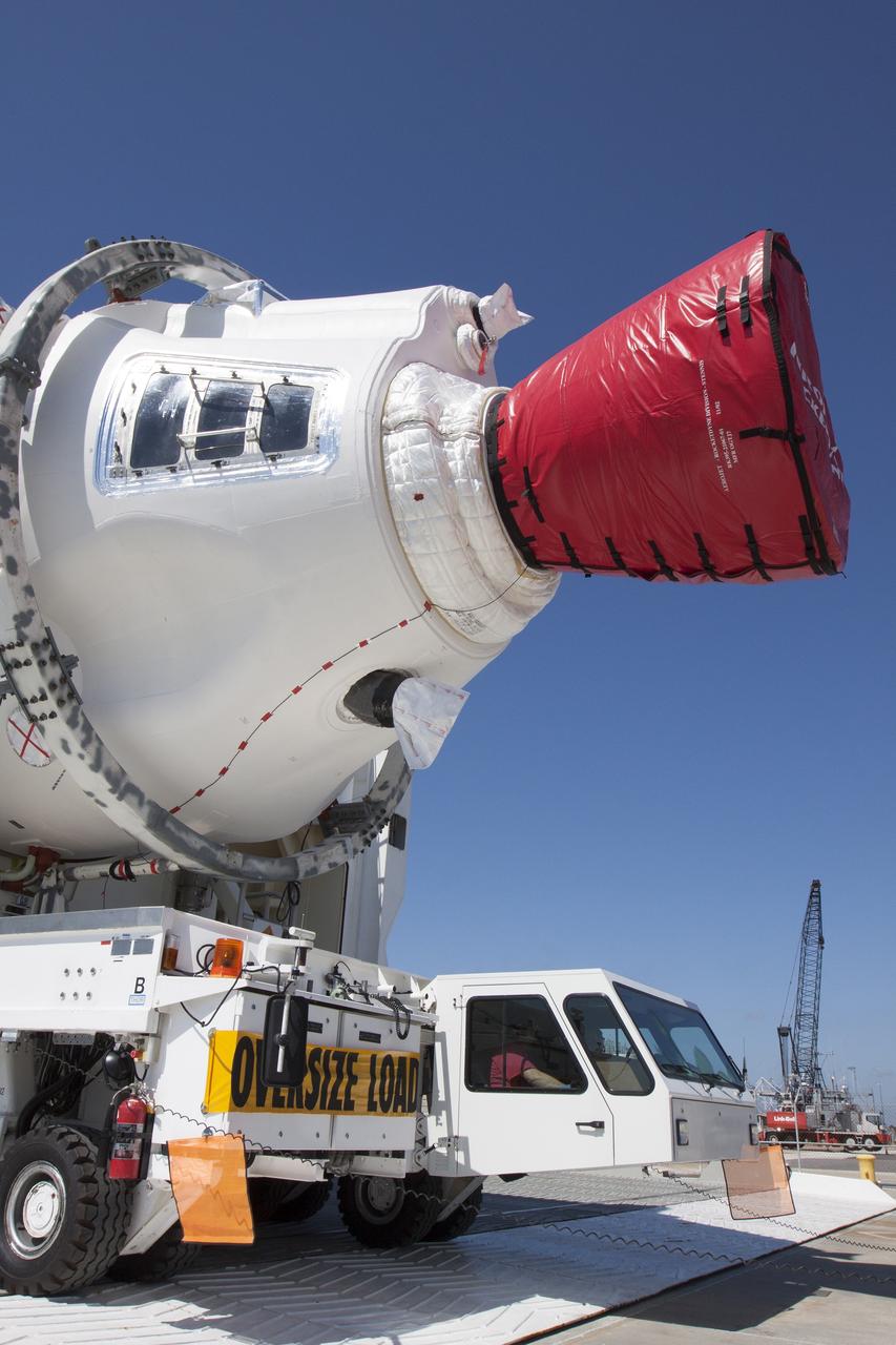 CAPE CANAVERAL, Fla. -- The port booster for the United Launch Alliance Delta IV Heavy for Exploration Flight Test-1, or EFT-1, has been offloaded from the barge at the U.S. Army Outpost wharf at Port Canaveral in Florida and will be transported to the Horizontal Integration Facility, or HIF, at Space Launch Complex 37 on Cape Canaveral Air Force Station. The upper stage and spacecraft adapter arrived with the booster and were transported to the HIF on May 6.    At the HIF, all three booster stages will be processed and checked out before being moved to the nearby launch pad and hoisted into position. The spacecraft adapter will connect Orion to the ULA Delta IV, and also will connect Orion to NASA's new rocket, the Space Launch System, on its first mission in 2017. During the EFT-1 mission, Orion will travel farther into space than any human spacecraft has gone in more than 40 years. The data gathered during the flight will influence design decisions, validate existing computer models and innovative new approaches to space systems development, as well as reduce overall mission risks and costs for later Orion flights. Liftoff of Orion on EFT-1 is planned for fall 2014. Photo credit: NASA/Kim Shiflett