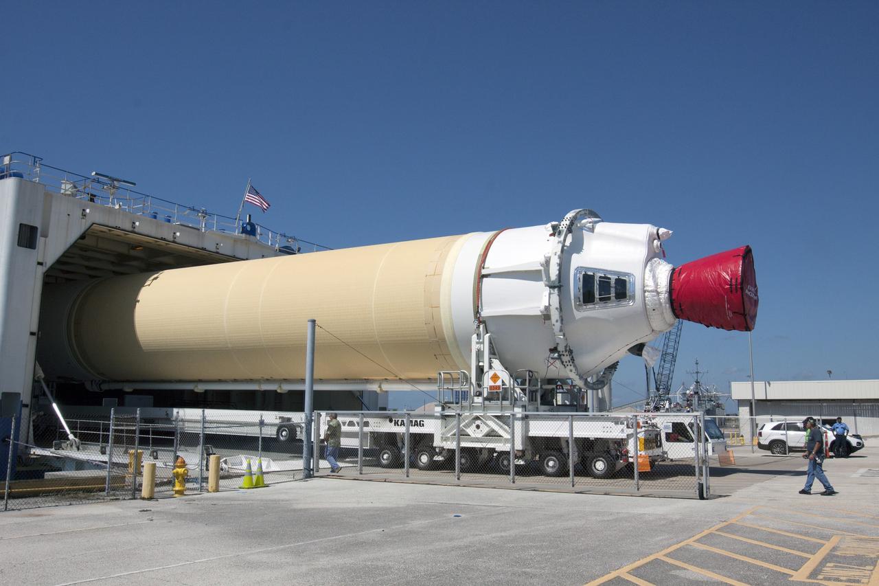 CAPE CANAVERAL, Fla. -- The port booster for the United Launch Alliance Delta IV Heavy for Exploration Flight Test-1, or EFT-1, has been offloaded from the barge at the U.S. Army Outpost wharf at Port Canaveral in Florida and will be transported to the Horizontal Integration Facility, or HIF, at Space Launch Complex 37 on Cape Canaveral Air Force Station. The upper stage and spacecraft adapter arrived with the booster and were transported to the HIF on May 6.    At the HIF, all three booster stages will be processed and checked out before being moved to the nearby launch pad and hoisted into position. The spacecraft adapter will connect Orion to the ULA Delta IV, and also will connect Orion to NASA's new rocket, the Space Launch System, on its first mission in 2017. During the EFT-1 mission, Orion will travel farther into space than any human spacecraft has gone in more than 40 years. The data gathered during the flight will influence design decisions, validate existing computer models and innovative new approaches to space systems development, as well as reduce overall mission risks and costs for later Orion flights. Liftoff of Orion on EFT-1 is planned for fall 2014. Photo credit: NASA/Kim Shiflett