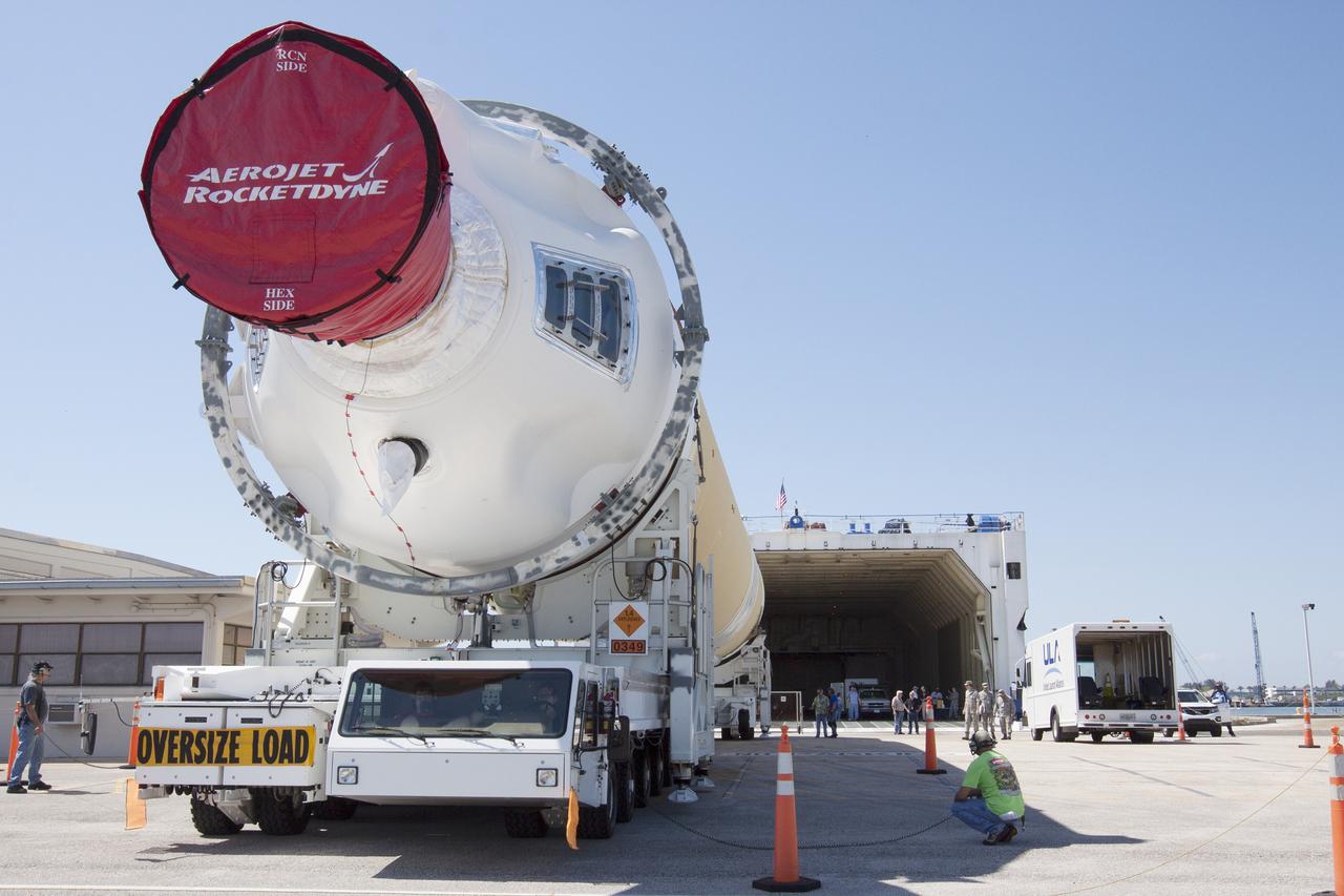 CAPE CANAVERAL, Fla. -- The port booster for the United Launch Alliance Delta IV Heavy for Exploration Flight Test-1, or EFT-1, has been offloaded from the barge at the U.S. Army Outpost wharf at Port Canaveral in Florida and will be transported to the Horizontal Integration Facility, or HIF, at Space Launch Complex 37 on Cape Canaveral Air Force Station. The upper stage and spacecraft adapter arrived with the booster and were transported to the HIF on May 6.    At the HIF, all three booster stages will be processed and checked out before being moved to the nearby launch pad and hoisted into position. The spacecraft adapter will connect Orion to the ULA Delta IV, and also will connect Orion to NASA's new rocket, the Space Launch System, on its first mission in 2017. During the EFT-1 mission, Orion will travel farther into space than any human spacecraft has gone in more than 40 years. The data gathered during the flight will influence design decisions, validate existing computer models and innovative new approaches to space systems development, as well as reduce overall mission risks and costs for later Orion flights. Liftoff of Orion on EFT-1 is planned for fall 2014. Photo credit: NASA/Kim Shiflett