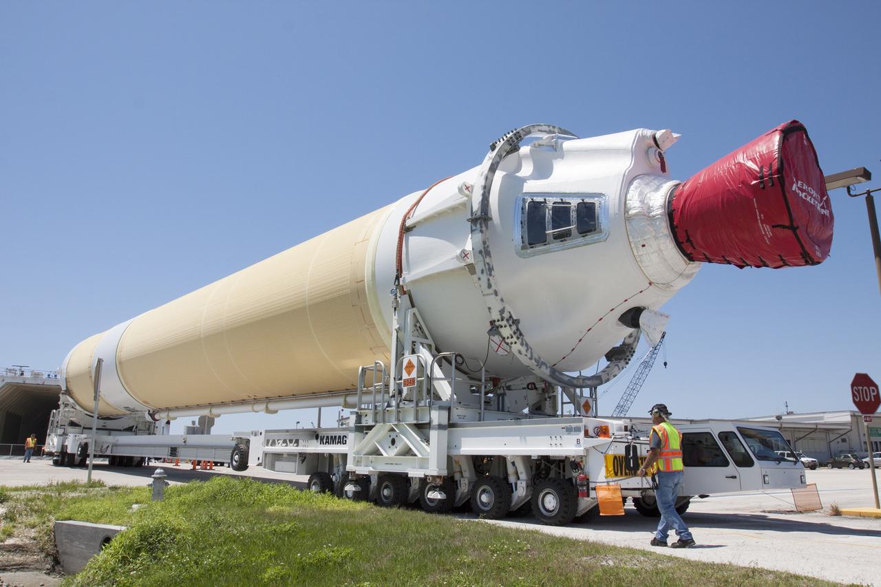 CAPE CANAVERAL, Fla. -- The port booster for the United Launch Alliance Delta IV Heavy for Exploration Flight Test-1, or EFT-1, has been offloaded from the barge at the U.S. Army Outpost wharf at Port Canaveral in Florida and is being transported to the Horizontal Integration Facility, or HIF, at Space Launch Complex 37 on Cape Canaveral Air Force Station. The upper stage and spacecraft adapter arrived with the booster and were transported to the HIF on May 6.    At the HIF, all three booster stages will be processed and checked out before being moved to the nearby launch pad and hoisted into position. The spacecraft adapter will connect Orion to the ULA Delta IV, and also will connect Orion to NASA's new rocket, the Space Launch System, on its first mission in 2017. During the EFT-1 mission, Orion will travel farther into space than any human spacecraft has gone in more than 40 years. The data gathered during the flight will influence design decisions, validate existing computer models and innovative new approaches to space systems development, as well as reduce overall mission risks and costs for later Orion flights. Liftoff of Orion on EFT-1 is planned for fall 2014. Photo credit: NASA/Kim Shiflett