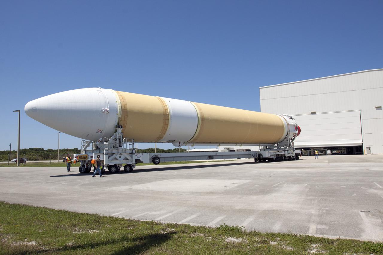 CAPE CANAVERAL, Fla. -- A transporter for oversize loads carries the port booster for the United Launch Alliance Delta IV Heavy for Exploration Flight Test-1, or EFT-1, to Space Launch Complex 37 on Cape Canaveral Air Force Station after it was offloaded from the barge at the U.S. Army Outpost wharf at Port Canaveral in Florida. The booster will be transported to the Horizontal Integration Facility, or HIF, at the launch complex. The upper stage and spacecraft adapter arrived with the booster and were transported to the HIF on May 6.    At the HIF, all three booster stages will be processed and checked out before being moved to the nearby launch pad and hoisted into position. The spacecraft adapter will connect Orion to the ULA Delta IV, and also will connect Orion to NASA's new rocket, the Space Launch System, on its first mission in 2017. During the EFT-1 mission, Orion will travel farther into space than any human spacecraft has gone in more than 40 years. The data gathered during the flight will influence design decisions, validate existing computer models and innovative new approaches to space systems development, as well as reduce overall mission risks and costs for later Orion flights. Liftoff of Orion on EFT-1 is planned for fall 2014. Photo credit: NASA/Kim Shiflett