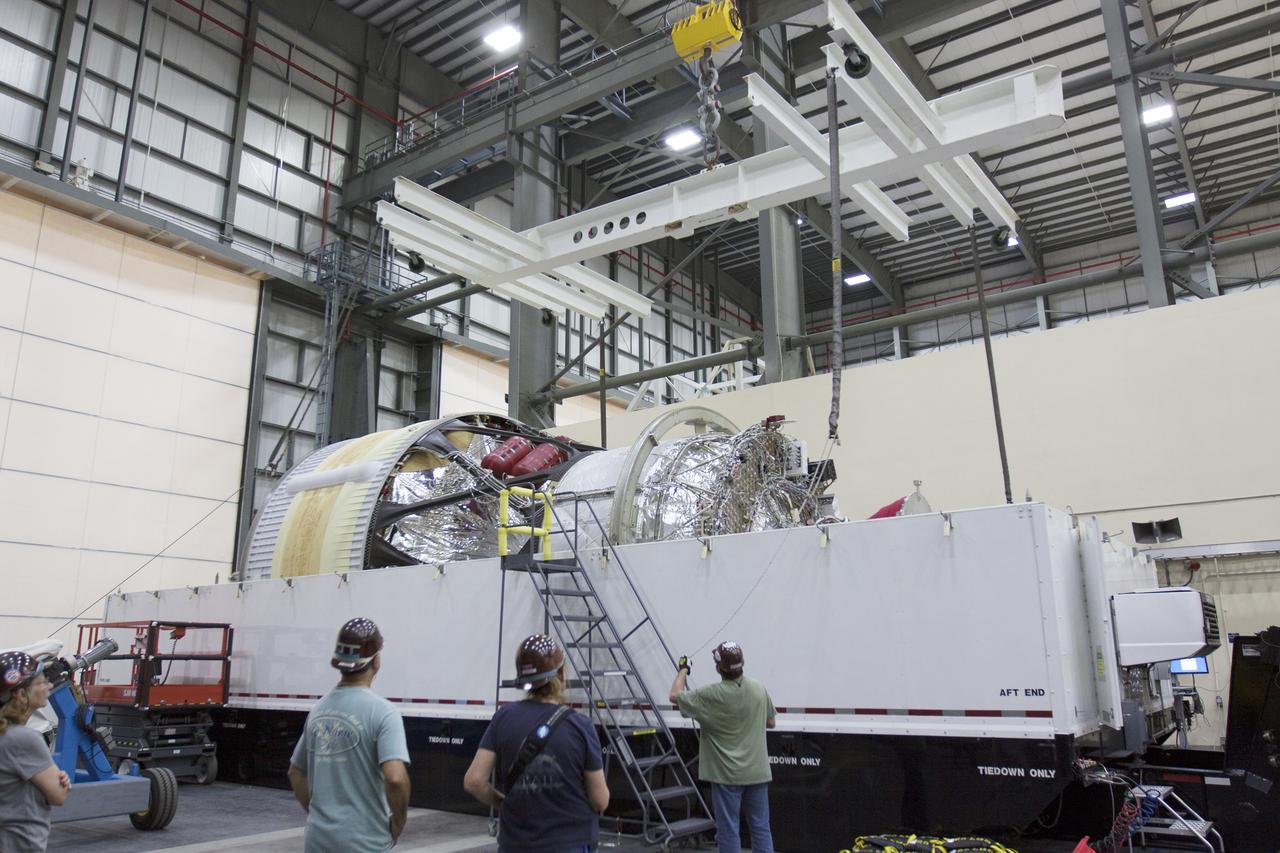 CAPE CANAVERAL, Fla. -- Inside the Horizontal Integration Facility, or HIF, at Space Launch Complex 37 on Cape Canaveral Air Force Station in Florida, the upper stage for the United Launch Alliance Delta IV Heavy for Exploration Flight Test-1, or EFT-1, is being prepared for removal from its transportation container. The upper stage, along with the port booster and spacecraft adapter arrived by barge at the U.S. Army Outpost wharf at Port Canaveral in Florida and were transported to the HIF.    At the HIF, all three booster stages will be processed and checked out before being moved to the nearby launch pad and hoisted into position. The spacecraft adapter will connect Orion to the ULA Delta IV, and also will connect Orion to NASA's new rocket, the Space Launch System, on its first mission in 2017. During the EFT-1 mission, Orion will travel farther into space than any human spacecraft has gone in more than 40 years. The data gathered during the flight will influence design decisions, validate existing computer models and innovative new approaches to space systems development, as well as reduce overall mission risks and costs for later Orion flights. Liftoff of Orion on EFT-1 is planned for fall 2014. Photo credit: NASA/Kim Shiflett