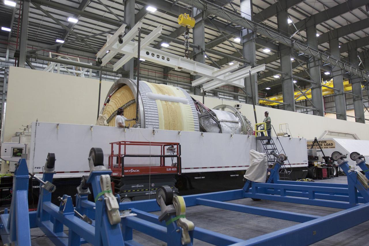 CAPE CANAVERAL, Fla. -- Inside the Horizontal Integration Facility, or HIF, at Space Launch Complex 37 on Cape Canaveral Air Force Station in Florida, the upper stage for the United Launch Alliance Delta IV Heavy for Exploration Flight Test-1, or EFT-1, is being prepared for removal from its transportation container. The upper stage, along with the port booster and spacecraft adapter arrived by barge at the U.S. Army Outpost wharf at Port Canaveral in Florida and were transported to the HIF.    At the HIF, all three booster stages will be processed and checked out before being moved to the nearby launch pad and hoisted into position. The spacecraft adapter will connect Orion to the ULA Delta IV, and also will connect Orion to NASA's new rocket, the Space Launch System, on its first mission in 2017. During the EFT-1 mission, Orion will travel farther into space than any human spacecraft has gone in more than 40 years. The data gathered during the flight will influence design decisions, validate existing computer models and innovative new approaches to space systems development, as well as reduce overall mission risks and costs for later Orion flights. Liftoff of Orion on EFT-1 is planned for fall 2014. Photo credit: NASA/Kim Shiflett