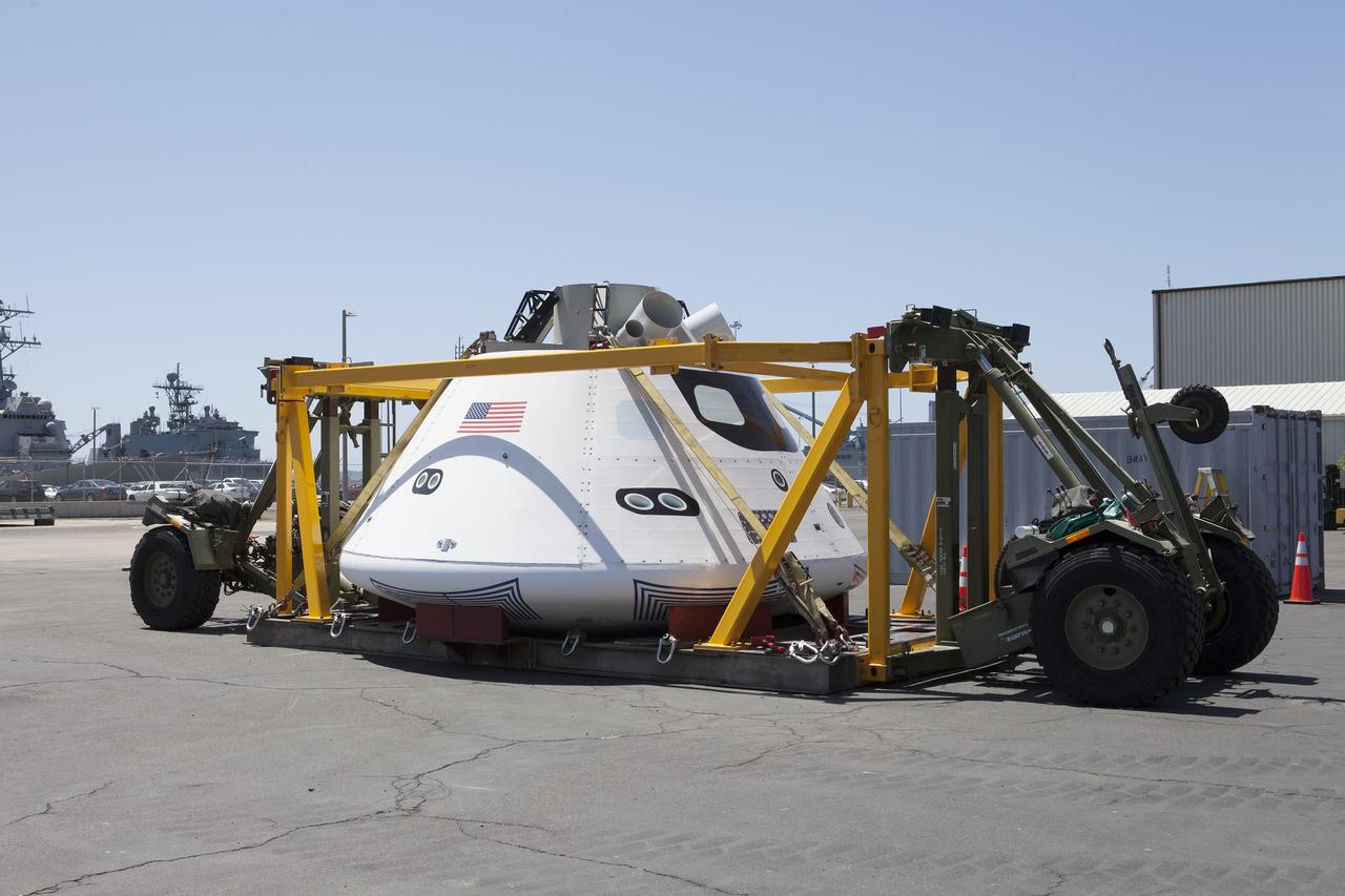 SAN DIEGO, Calif. – The Orion boilerplate test vehicle has been secured in the crew module recovery cradle at a warehouse at the Naval Base San Diego in California. The Ground Systems Development and Operations Program, Lockheed Martin and the U.S. Navy are evaluating the hardware and processes for preparing the Orion crew module for Exploration Flight Test-1, or EFT-1, for overland transport from the naval base to NASA's Kennedy Space Center in Florida.    Orion is the exploration spacecraft designed to carry astronauts to destinations not yet explored by humans, including an asteroid and Mars. It will have emergency abort capability, sustain the crew during space travel and provide safe re-entry from deep space return velocities. The first unpiloted test flight of the Orion is scheduled to launch later this year atop a Delta IV rocket from Cape Canaveral Air Force Station in Florida to an altitude of 3,600 miles above the Earth's surface. The two-orbit, four-hour flight test will help engineers evaluate the systems critical to crew safety including the heat shield, parachute system and launch abort system. For more information, visit http://www.nasa.gov/orion. Photo credit: NASA/Kim Shiflett