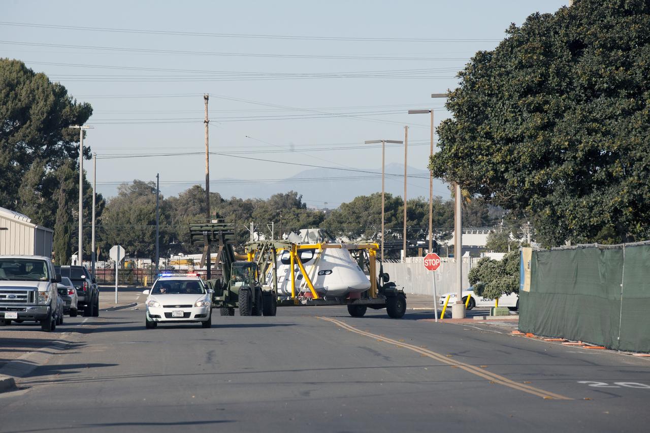 SAN DIEGO, Calif. – The Orion boilerplate test vehicle is being moved from the Mole Pier at Naval Base San Diego in California to a warehouse at the naval base. The test vehicle is attached to the crew module recovery cradle. The Ground Systems Development and Operations Program, Lockheed Martin and the U.S. Navy are evaluating the hardware and processes for preparing the Orion crew module for Exploration Flight Test-1, or EFT-1, for overland transport from the naval base to NASA's Kennedy Space Center in Florida. Orion is the exploration spacecraft designed to carry astronauts to destinations not yet explored by humans, including an asteroid and Mars. It will have emergency abort capability, sustain the crew during space travel and provide safe re-entry from deep space return velocities. The first unpiloted test flight of the Orion is scheduled to launch later this year atop a Delta IV rocket from Cape Canaveral Air Force Station in Florida to an altitude of 3,600 miles above the Earth's surface. The two-orbit, four-hour flight test will help engineers evaluate the systems critical to crew safety including the heat shield, parachute system and launch abort system. For more information, visit http://www.nasa.gov/orion. Photo credit: NASA/Kim Shiflett