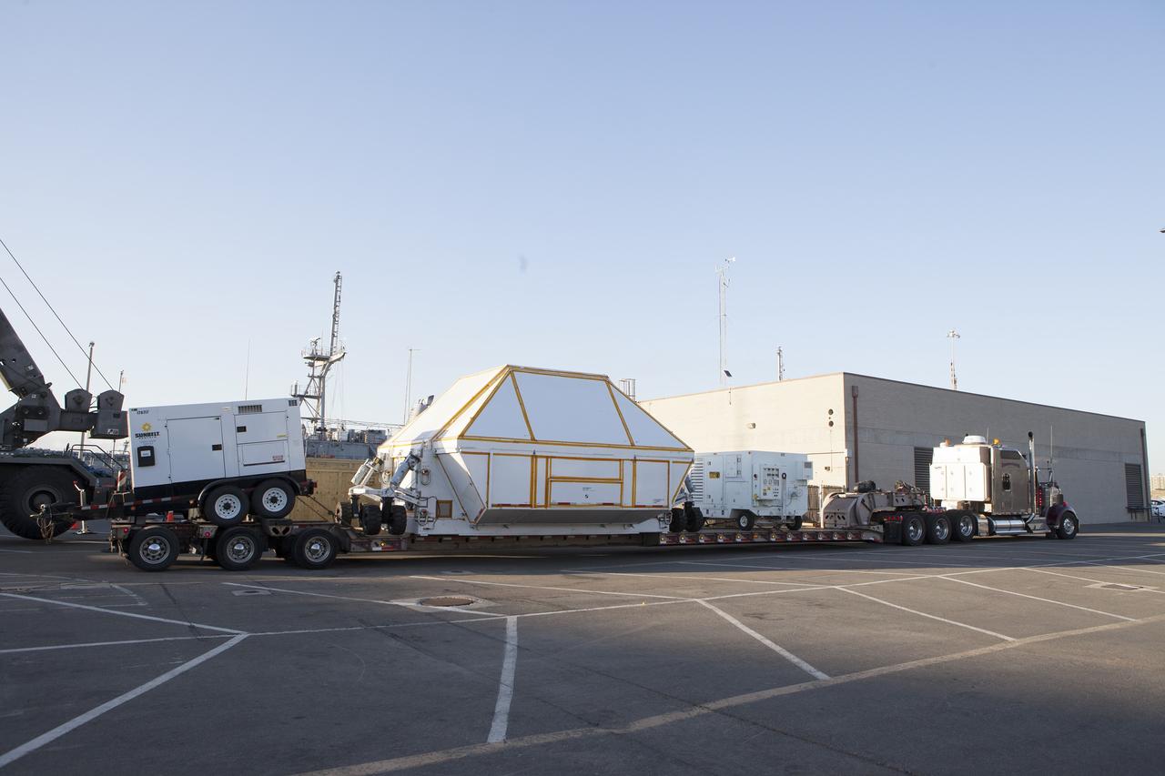 SAN DIEGO, Calif. – At the Mole Pier at Naval Base San Diego in California, the crew module transportation fixture has been secured on a flatbed truck, simulating readiness for Orion's cross-country trip. The Ground Systems Development and Operations Program, Lockheed Martin and the U.S. Navy are evaluating the hardware and processes for preparing the Orion crew module for Exploration Flight Test-1, or EFT-1, for overland transport from the naval base to NASA's Kennedy Space Center in Florida.    Orion is the exploration spacecraft designed to carry astronauts to destinations not yet explored by humans, including an asteroid and Mars. It will have emergency abort capability, sustain the crew during space travel and provide safe re-entry from deep space return velocities. The first unpiloted test flight of the Orion is scheduled to launch later this year atop a Delta IV rocket from Cape Canaveral Air Force Station in Florida to an altitude of 3,600 miles above the Earth's surface. The two-orbit, four-hour flight test will help engineers evaluate the systems critical to crew safety including the heat shield, parachute system and launch abort system. For more information, visit http://www.nasa.gov/orion. Photo credit: NASA/Kim Shiflett