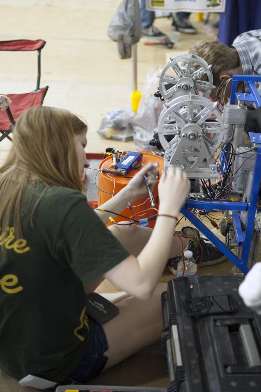 CAPE CANAVERAL, Fla. – College students prepare their robot for NASA’s Robotics Mining Competition at the Kennedy Space Center Visitor Complex in Florida. More than 35 teams from around the U.S. have designed and built remote-controlled robots for the mining competition. The competition is a NASA Human Exploration and Operations Mission Directorate project designed to engage and retain students in science, technology, engineering and mathematics, or STEM, fields by expanding opportunities for student research and design. Teams use their remote-controlled robotics to maneuver and dig in a supersized sandbox filled with a crushed material that has characteristics similar to Martian soil. The objective of the challenge is to see which team’s robot can collect and move the most regolith within a specified amount of time. For more information, visit www.nasa.gov/nasarmc. Photo credit: NASA/Ben Smegelsky