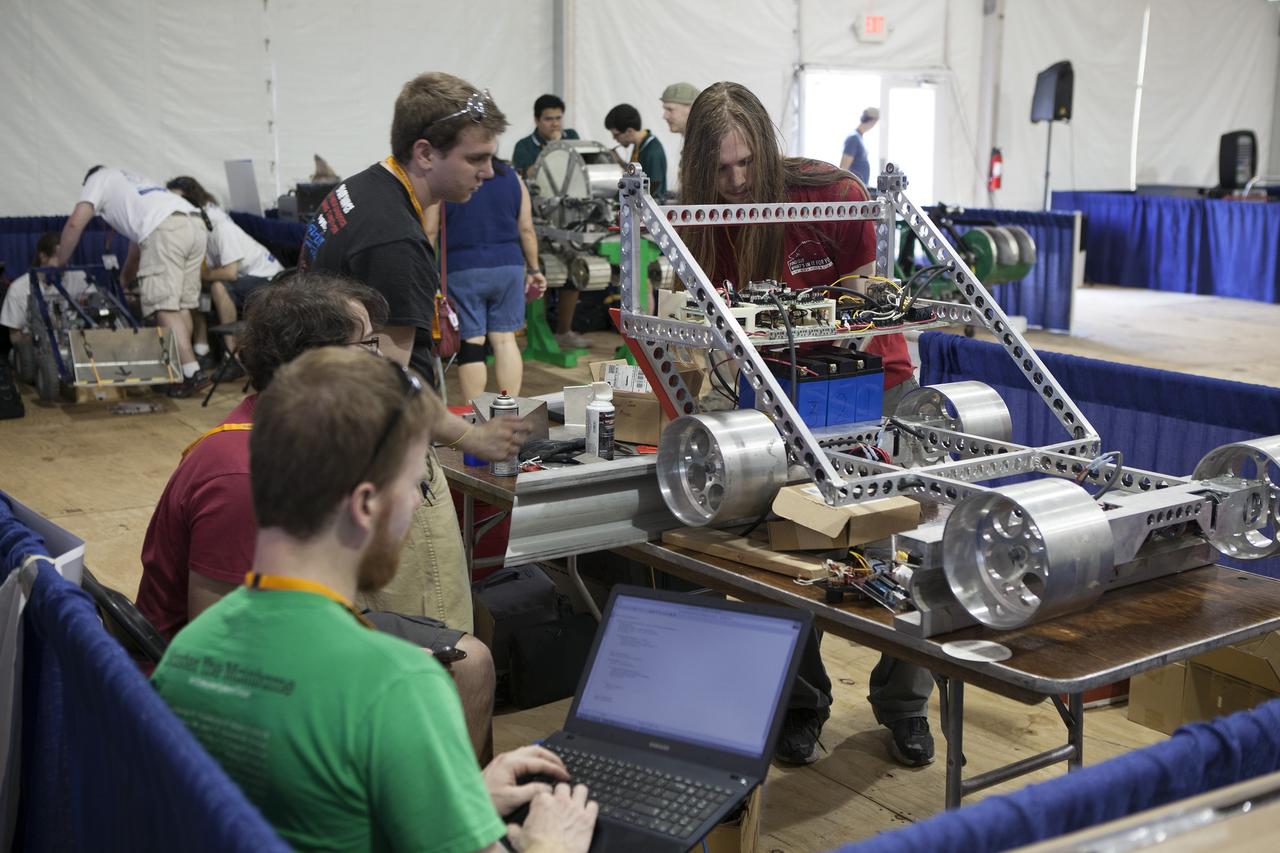 CAPE CANAVERAL, Fla. – College students prepare their robot for NASA’s Robotics Mining Competition at the Kennedy Space Center Visitor Complex in Florida. More than 35 teams from around the U.S. have designed and built remote-controlled robots for the mining competition. The competition is a NASA Human Exploration and Operations Mission Directorate project designed to engage and retain students in science, technology, engineering and mathematics, or STEM, fields by expanding opportunities for student research and design. Teams use their remote-controlled robotics to maneuver and dig in a supersized sandbox filled with a crushed material that has characteristics similar to Martian soil. The objective of the challenge is to see which team’s robot can collect and move the most regolith within a specified amount of time. For more information, visit www.nasa.gov/nasarmc. Photo credit: NASA/Ben Smegelsky