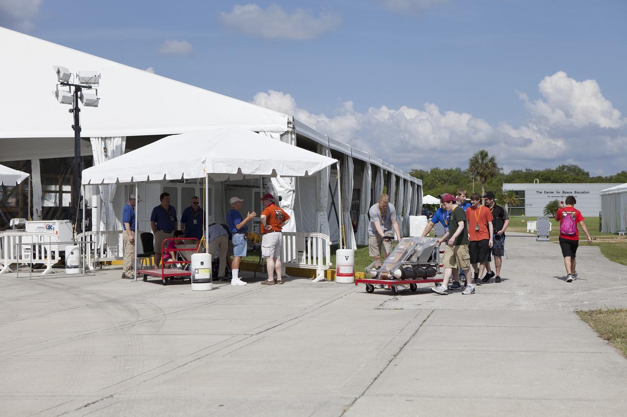 CAPE CANAVERAL, Fla. – A college team prepares its robot for a trial run at NASA’s Robotics Mining Competition at the Kennedy Space Center Visitor Complex in Florida. More than 35 teams from around the U.S. have designed and built remote-controlled robots for the mining competition. The competition is a NASA Human Exploration and Operations Mission Directorate project designed to engage and retain students in science, technology, engineering and mathematics, or STEM, fields by expanding opportunities for student research and design. Teams use their remote-controlled robotics to maneuver and dig in a supersized sandbox filled with a crushed material that has characteristics similar to Martian soil. The objective of the challenge is to see which team’s robot can collect and move the most regolith within a specified amount of time. For more information, visit www.nasa.gov/nasarmc. Photo credit: NASA/Ben Smegelsky
