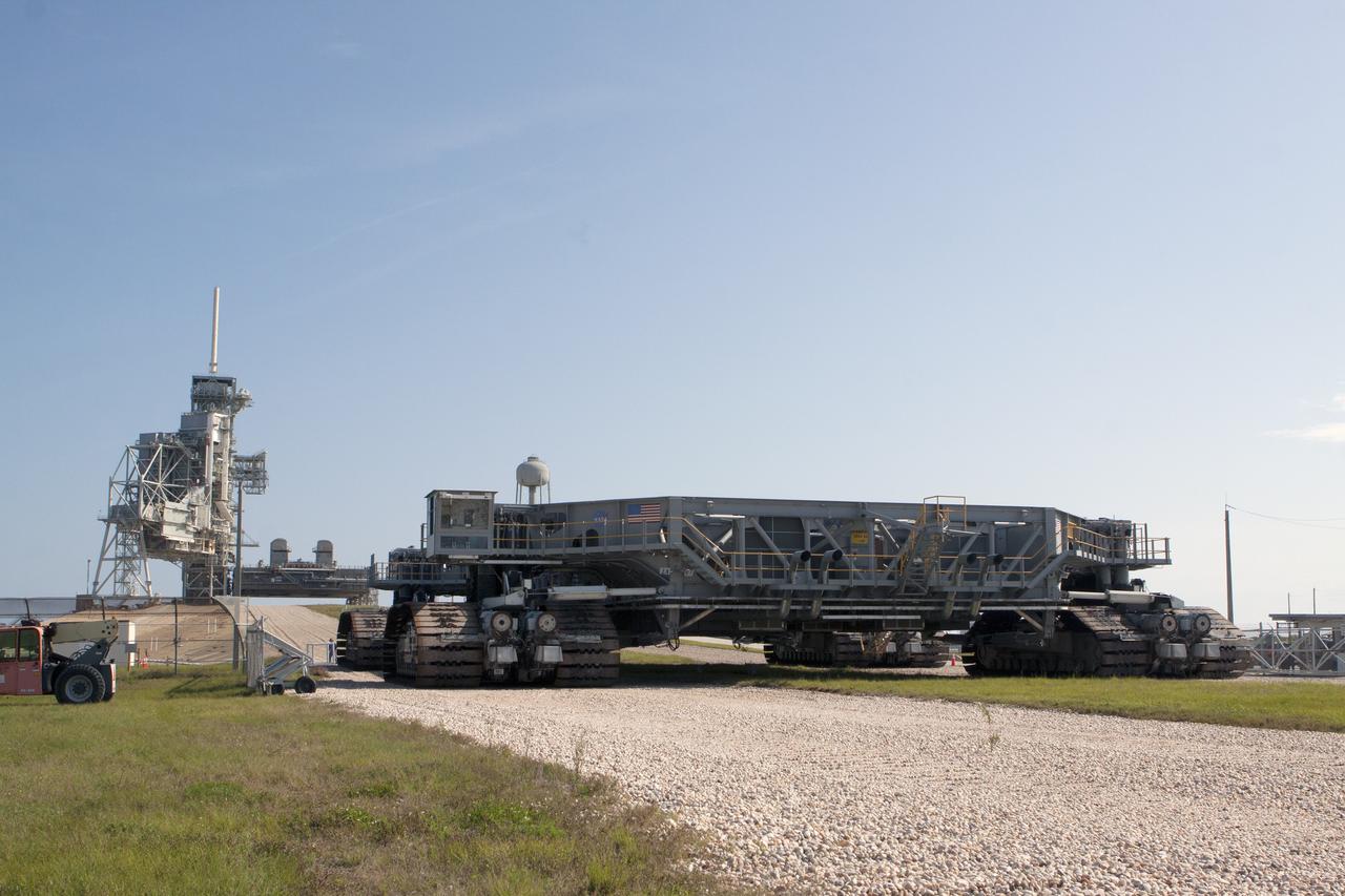 CAPE CANAVERAL, Fla. -- A crawler-transporter rolls toward Launch Pad 39A at NASA's Kennedy Space Center in Florida. Operations are underway to move Mobile Launcher Platform-2, or MLP-2, from the pad to a nearby park site in Launch Complex 39.      The historic launch pad was the site from which numerous Apollo and space shuttle missions began and is beginning a new mission as a commercial launch site. NASA signed a property agreement with Space Exploration Technologies Corp., or SpaceX, of Hawthorne, California, on April 14 for use and occupancy of the seaside complex along Florida's central east coast. It will serve as a platform for SpaceX to support their commercial launch activities.  For more information on Launch Pad 39A, visit http://www.nasa.gov/centers/kennedy/pdf/167416main_LC39-08.pdf. For learn more about the crawler-transporter, visit http://www.nasa.gov/centers/kennedy/pdf/167402main_crawlertransporters07.pdf. Photo credit: NASA/Kim Shiflett
