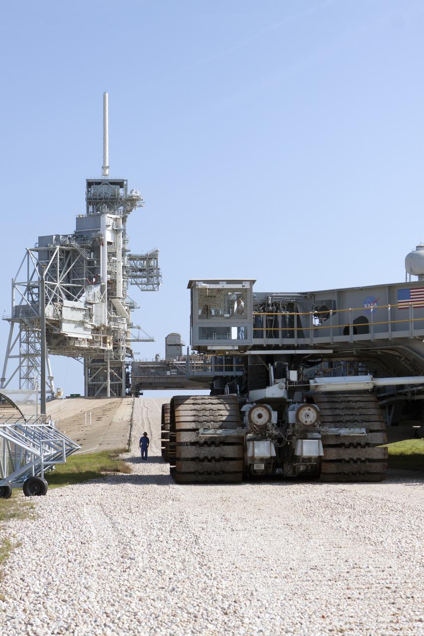 CAPE CANAVERAL, Fla. -- A crawler-transporter begins its climb to the hardstand at Launch Pad 39A at NASA's Kennedy Space Center in Florida. Operations are underway to move Mobile Launcher Platform-2, or MLP-2, from the pad to a nearby park site in Launch Complex 39.      The historic launch pad was the site from which numerous Apollo and space shuttle missions began and is beginning a new mission as a commercial launch site. NASA signed a property agreement with Space Exploration Technologies Corp., or SpaceX, of Hawthorne, California, on April 14 for use and occupancy of the seaside complex along Florida's central east coast. It will serve as a platform for SpaceX to support their commercial launch activities.  For more information on Launch Pad 39A, visit http://www.nasa.gov/centers/kennedy/pdf/167416main_LC39-08.pdf. For learn more about the crawler-transporter, visit http://www.nasa.gov/centers/kennedy/pdf/167402main_crawlertransporters07.pdf. Photo credit: NASA/Kim Shiflett