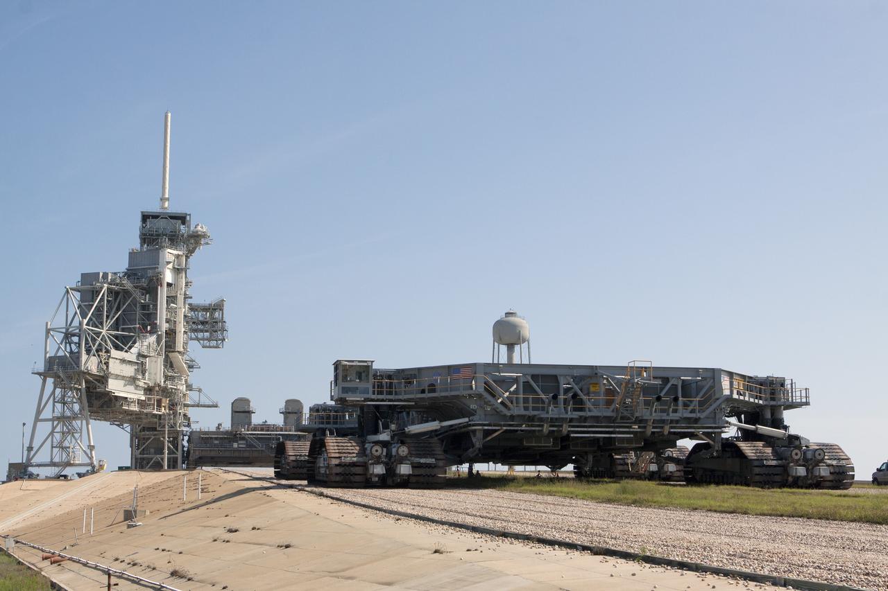 CAPE CANAVERAL, Fla. -- A crawler-transporter begins its climb toward Mobile Launcher Platform-2, or MLP-2, on the hardstand at Launch Pad 39A at NASA's Kennedy Space Center in Florida. Operations are underway to move the MLP to a nearby park site in Launch Complex 39.      The historic launch pad was the site from which numerous Apollo and space shuttle missions began and is beginning a new mission as a commercial launch site. NASA signed a property agreement with Space Exploration Technologies Corp., or SpaceX, of Hawthorne, California, on April 14 for use and occupancy of the seaside complex along Florida's central east coast. It will serve as a platform for SpaceX to support their commercial launch activities.  For more information on Launch Pad 39A, visit http://www.nasa.gov/centers/kennedy/pdf/167416main_LC39-08.pdf. For learn more about the crawler-transporter, visit http://www.nasa.gov/centers/kennedy/pdf/167402main_crawlertransporters07.pdf. Photo credit: NASA/Kim Shiflett