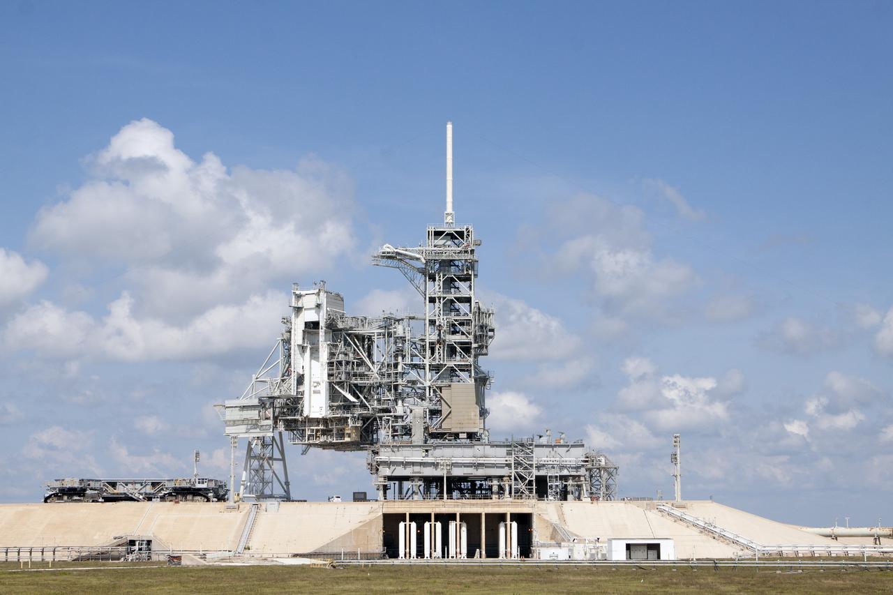 CAPE CANAVERAL, Fla. -- A crawler-transporter nears the Mobile Launcher Platform-2, or MLP-2, positioned over the flame trench at Launch Pad 39A at NASA's Kennedy Space Center in Florida. Operations are underway to move the MLP to a nearby park site in Launch Complex 39.      The historic launch pad was the site from which numerous Apollo and space shuttle missions began and is beginning a new mission as a commercial launch site. NASA signed a property agreement with Space Exploration Technologies Corp., or SpaceX, of Hawthorne, California, on April 14 for use and occupancy of the seaside complex along Florida's central east coast. It will serve as a platform for SpaceX to support their commercial launch activities.  For more information on Launch Pad 39A, visit http://www.nasa.gov/centers/kennedy/pdf/167416main_LC39-08.pdf. For learn more about the crawler-transporter, visit http://www.nasa.gov/centers/kennedy/pdf/167402main_crawlertransporters07.pdf. Photo credit: NASA/Kim Shiflett