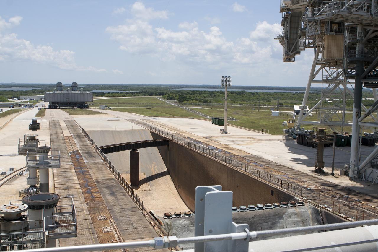 CAPE CANAVERAL, Fla. -- At NASA's Kennedy Space Center in Florida, Mobile Launcher Platform-2, or MLP-2, rolling away from Launch Pad 39A atop a crawler-transporter, was positioned over the pad's flame trench only moments before. The MLP is being moved to a nearby park site in Launch Complex 39.      The historic launch pad was the site from which numerous Apollo and space shuttle missions began and is beginning a new mission as a commercial launch site. NASA signed a property agreement with Space Exploration Technologies Corp., or SpaceX, of Hawthorne, California, on April 14 for use and occupancy of the seaside complex along Florida's central east coast. It will serve as a platform for SpaceX to support their commercial launch activities.  For more information on Launch Pad 39A, visit http://www.nasa.gov/centers/kennedy/pdf/167416main_LC39-08.pdf. For learn more about the crawler-transporter, visit http://www.nasa.gov/centers/kennedy/pdf/167402main_crawlertransporters07.pdf. Photo credit: NASA/Kim Shiflett