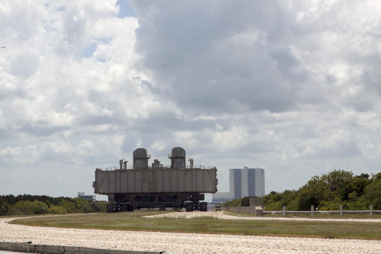 CAPE CANAVERAL, Fla. -- The crawler-transporter transporting Mobile Launcher Platform-2, or MLP-2, from Launch Pad 39A creeps along the crawlerway toward the Vehicle Assembly Building, or VAB, at NASA's Kennedy Space Center in Florida. The MLP is being moved to a nearby park site in Launch Complex 39.    The historic launch pad was the site from which numerous Apollo and space shuttle missions began and is beginning a new mission as a commercial launch site. NASA signed a property agreement with Space Exploration Technologies Corp., or SpaceX, of Hawthorne, California, on April 14 for use and occupancy of the seaside complex along Florida's central east coast. It will serve as a platform for SpaceX to support their commercial launch activities.  For more information on Launch Pad 39A, visit http://www.nasa.gov/centers/kennedy/pdf/167416main_LC39-08.pdf. For learn more about the crawler-transporter, visit http://www.nasa.gov/centers/kennedy/pdf/167402main_crawlertransporters07.pdf. Photo credit: NASA/Kim Shiflett