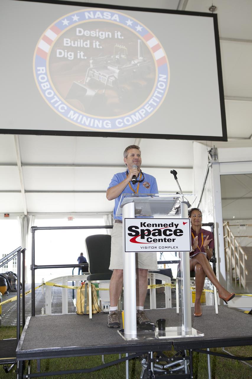CAPE CANAVERAL, Fla. – Rob Mueller, lead technical expert and head judge from Kennedy Space Center's Engineering and Technology Directorate, speaks to the college and university teams during the opening ceremony of NASA’s 2014 Robotics Mining Competition at the Kennedy Space Center Visitor Complex in Florida. More than 35 teams from around the U.S. have designed and built remote-controlled robots for the mining competition. The competition is a NASA Human Exploration and Operations Mission Directorate project designed to engage and retain students in science, technology, engineering and mathematics, or STEM, fields by expanding opportunities for student research and design. Teams use their remote-controlled robotics to maneuver and dig in a supersized sandbox filled with a crushed material that has characteristics similar to Martian soil. The objective of the challenge is to see which team’s robot can collect and move the most regolith within a specified amount of time. For more information, visit www.nasa.gov/nasarmc. Photo credit: NASA/Frankie Martin