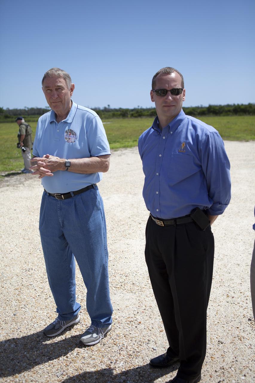 CAPE CANAVERAL, Fla. – From left, Chirold Epp, the Autonomous Landing and Hazard Avoidance Technology, or ALHAT, project manager, and Jon Olansen, Morpheus project manager, speak to members of the media near the north end of the Shuttle Landing Facility at NASA's Kennedy Space Center in Florida. Media also viewed Morpheus inside a facility near the landing facility. Project Morpheus tests NASA’s ALHAT and an engine that runs on liquid oxygen and methane, which are green propellants. These new capabilities could be used in future efforts to deliver cargo to planetary surfaces.    The landing facility provides the lander with the kind of field necessary for realistic testing, complete with rocks, craters and hazards to avoid. Morpheus’ ALHAT payload allows it to navigate to clear landing sites amidst rocks, craters and other hazards during its descent. Project Morpheus is being managed under the Advanced Exploration Systems, or AES, Division in NASA’s Human Exploration and Operations Mission Directorate. The efforts in AES pioneer new approaches for rapidly developing prototype systems, demonstrating key capabilities and validating operational concepts for future human missions beyond Earth orbit. For more information on Project Morpheus, visit http://morpheuslander.jsc.nasa.gov/.  Photo credit: NASA/Frankie Martin