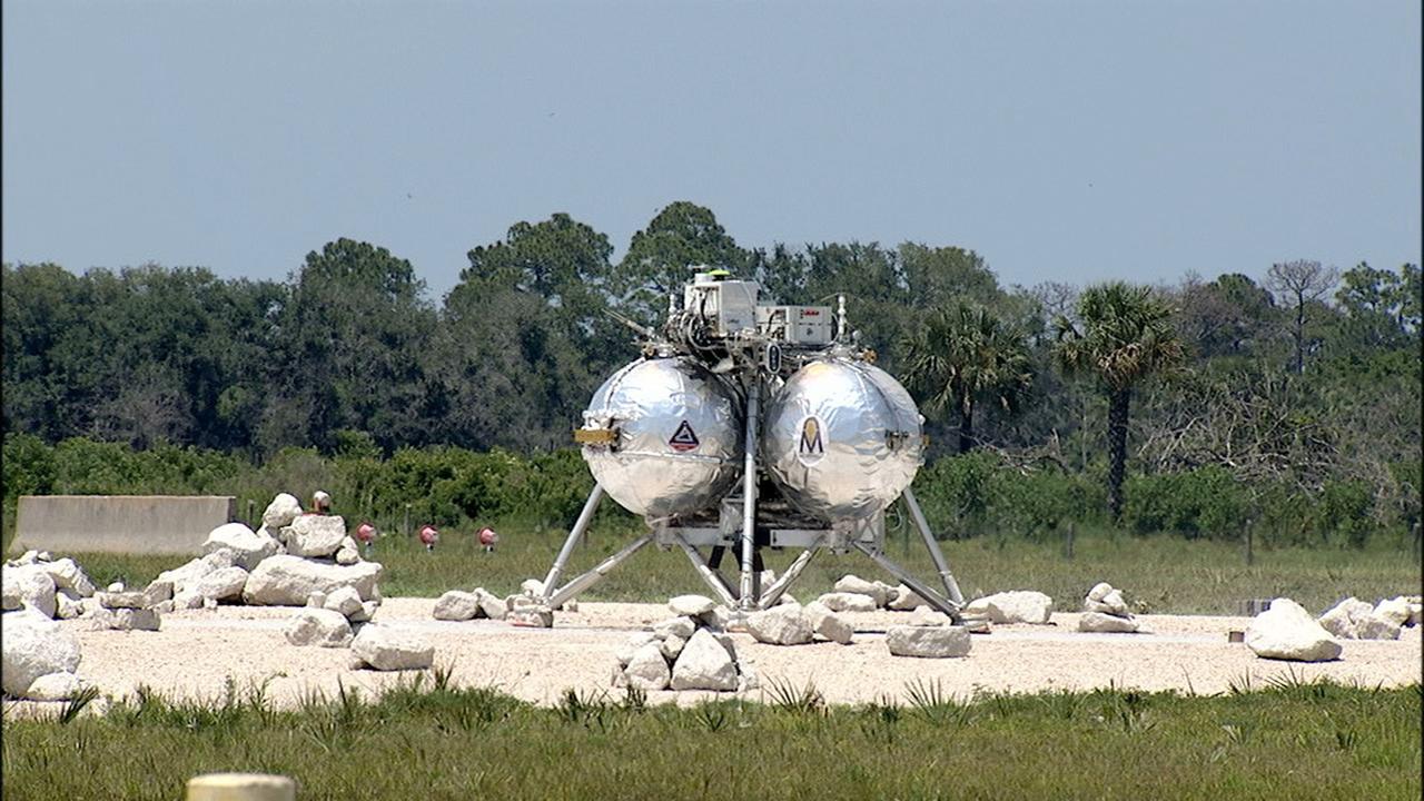 CAPE CANAVERAL, Fla. –At NASA's Kennedy Space Center in Florida, the agency's Project Morpheus prototype lander just touched down on a dedicated pad inside the ALHAT hazard field near the Shuttle Landing Facility. Project Morpheus tests NASA’s ALHAT and an engine that runs on liquid oxygen and methane, which are green propellants. These new capabilities could be used in future efforts to deliver cargo to planetary surfaces.      The landing facility provides the lander with the kind of field necessary for realistic testing, complete with rocks, craters and hazards to avoid. Morpheus’ ALHAT payload allows it to navigate to clear landing sites amidst rocks, craters and other hazards during its descent. Project Morpheus is being managed under the Advanced Exploration Systems, or AES, Division in NASA’s Human Exploration and Operations Mission Directorate. The efforts in AES pioneer new approaches for rapidly developing prototype systems, demonstrating key capabilities and validating operational concepts for future human missions beyond Earth orbit. For more information on Project Morpheus, visit http://morpheuslander.jsc.nasa.gov/. Photo credit: NASA/Mike Chambers and Chris Chamberland