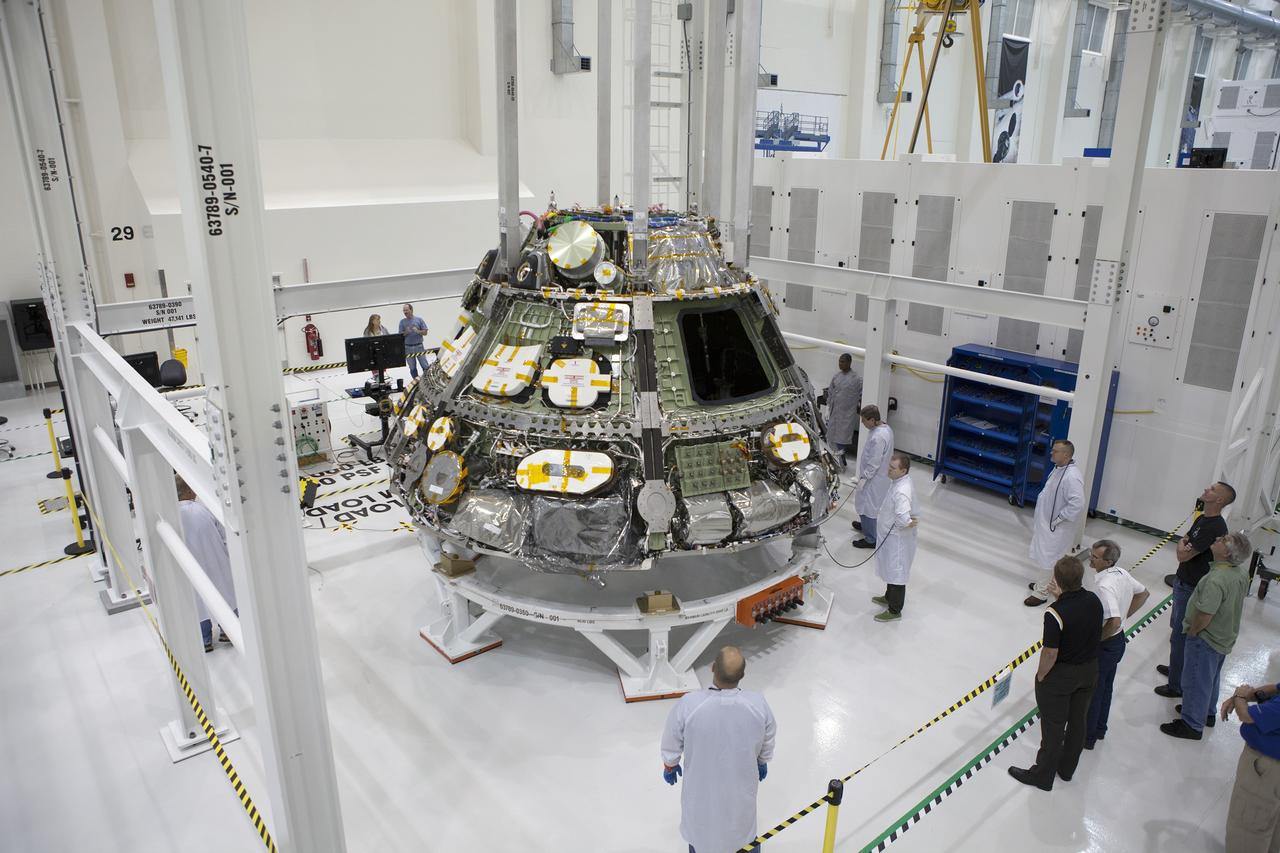 CAPE CANAVERAL, Fla. – Inside the Operations and Checkout Building high bay at NASA's Kennedy Space Center in Florida, Lockheed Martin technicians check the Orion crew module before it is lifted from a test stand. Activities are underway to lift Orion and prepare it for future installation of the heat shield.     Orion is the exploration spacecraft designed to carry astronauts to destinations not yet explored by humans, including an asteroid and Mars. It will have emergency abort capability, sustain the crew during space travel and provide safe re-entry from deep space return velocities. The first unpiloted test flight of the Orion is scheduled to launch in 2014 atop a Delta IV rocket and in 2017 on NASA’s Space Launch System rocket. For more information, visit http://www.nasa.gov/orion. Photo credit: NASA/Dimitri Gerondidakis