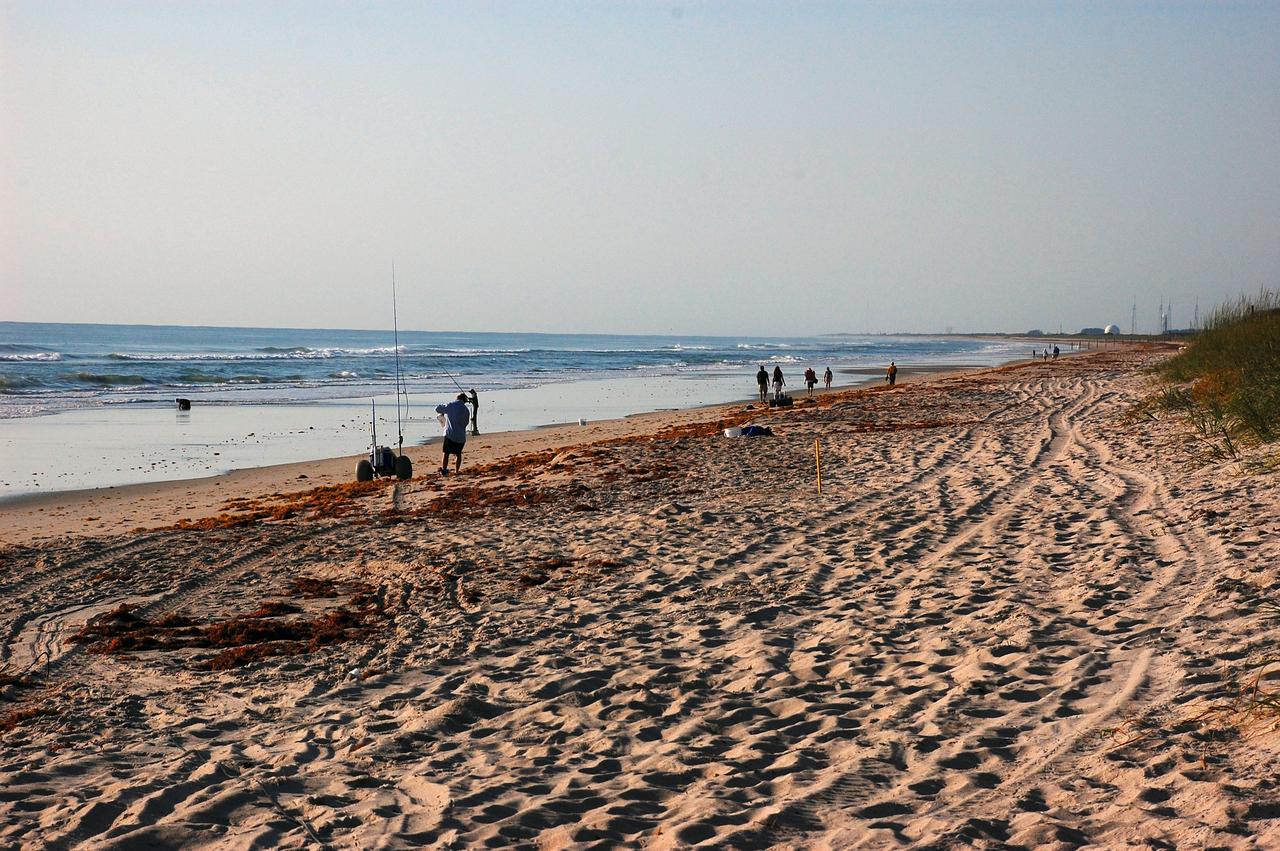 CAPE CANAVERAL, Fla. -- A balmy May morning finds visitors to Playalinda Beach in Florida enjoying the water, fishing and walking along the shore. The beach borders NASA's Kennedy Space Center to the north.    On this particular morning, preparations are underway for a launch from Space Launch Complex-41 on Cape Canaveral Air Force Station, a part of the spaceport which neighbors Kennedy Space Center.  For more information, visit http://www.nasa.gov/centers/kennedy.  Photo credit: NASA/Ben Smegelsky