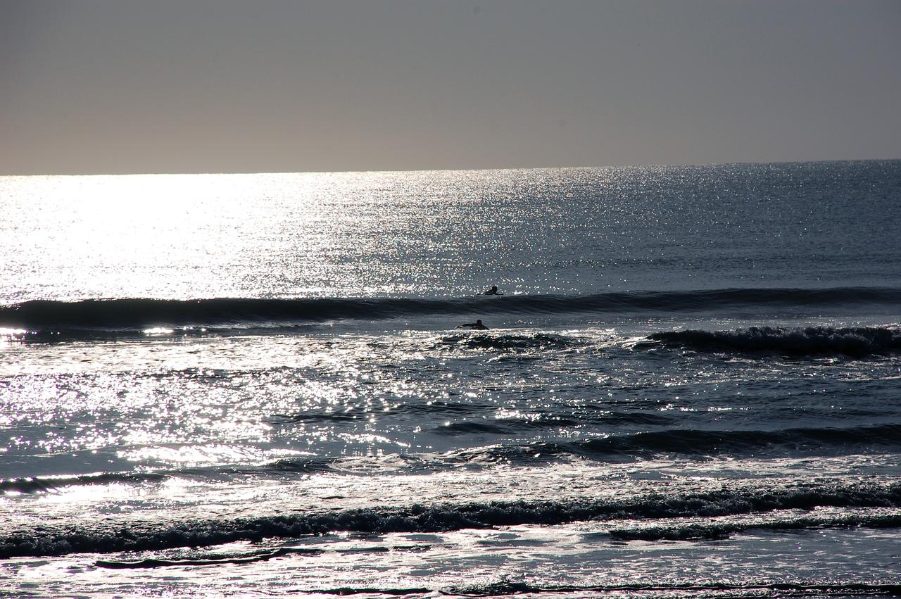 CAPE CANAVERAL, Fla. -- A balmy May morning finds surfers out to catch the waves at Playalinda Beach in Florida. The beach borders NASA's Kennedy Space Center to the north.    On this particular morning, preparations are underway for a launch from Space Launch Complex-41 on Cape Canaveral Air Force Station, a part of the spaceport which neighbors Kennedy Space Center.  For more information, visit http://www.nasa.gov/centers/kennedy.  Photo credit: NASA/Ben Smegelsky