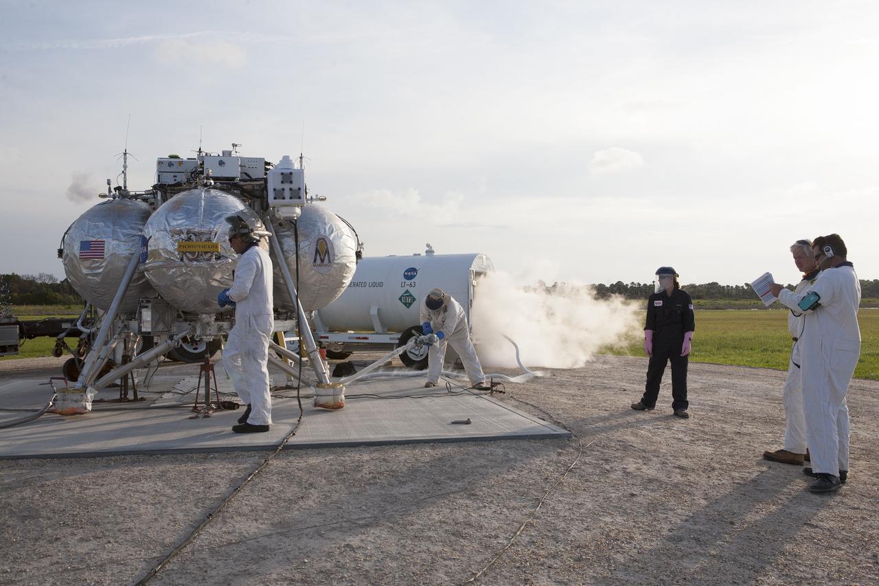 CAPE CANAVERAL, Fla. -- Preparations are underway for the first free-flight test of NASA's Project Morpheus prototype lander at night from a launch pad at the north end of the Shuttle Landing Facility at NASA’s Kennedy Space Center in Florida. The 98-second test began at 10:02 p.m. EDT with the Morpheus lander launching from the ground over a flame trench and ascending more than 800 feet. The vehicle, with its autonomous landing and hazard avoidance technology, or ALHAT sensors, surveyed the hazard field to determine safe landing sites. Morpheus then flew forward and downward covering approximately 1,300 feet while performing a 78-foot divert to simulate a hazard avoidance maneuver. The lander then descended and landed on a dedicated pad inside the test field. Project Morpheus tests NASA’s ALHAT and an engine that runs on liquid oxygen and methane, which are green propellants. These new capabilities could be used in future efforts to deliver cargo to planetary surfaces. The landing facility provides the lander with the kind of field necessary for realistic testing, complete with rocks, craters and hazards to avoid. Morpheus’ ALHAT payload allows it to navigate to clear landing sites amidst rocks, craters and other hazards during its descent. Project Morpheus is being managed under the Advanced Exploration Systems, or AES, Division in NASA’s Human Exploration and Operations Mission Directorate. The efforts in AES pioneer new approaches for rapidly developing prototype systems, demonstrating key capabilities and validating operational concepts for future human missions beyond Earth orbit. For more information on Project Morpheus, visit http://morpheuslander.jsc.nasa.gov/. Photo credit: NASA/Kim Shiflett