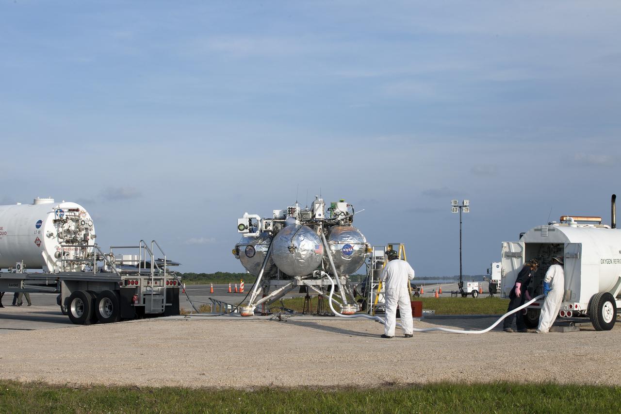 CAPE CANAVERAL, Fla. -- Preparations are underway for the first free-flight test of NASA's Project Morpheus prototype lander at night from a launch pad at the north end of the Shuttle Landing Facility at NASA’s Kennedy Space Center in Florida. The 98-second test began at 10:02 p.m. EDT with the Morpheus lander launching from the ground over a flame trench and ascending more than 800 feet. The vehicle, with its autonomous landing and hazard avoidance technology, or ALHAT sensors, surveyed the hazard field to determine safe landing sites. Morpheus then flew forward and downward covering approximately 1,300 feet while performing a 78-foot divert to simulate a hazard avoidance maneuver. The lander then descended and landed on a dedicated pad inside the test field. Project Morpheus tests NASA’s ALHAT and an engine that runs on liquid oxygen and methane, which are green propellants. These new capabilities could be used in future efforts to deliver cargo to planetary surfaces. The landing facility provides the lander with the kind of field necessary for realistic testing, complete with rocks, craters and hazards to avoid. Morpheus’ ALHAT payload allows it to navigate to clear landing sites amidst rocks, craters and other hazards during its descent. Project Morpheus is being managed under the Advanced Exploration Systems, or AES, Division in NASA’s Human Exploration and Operations Mission Directorate. The efforts in AES pioneer new approaches for rapidly developing prototype systems, demonstrating key capabilities and validating operational concepts for future human missions beyond Earth orbit. For more information on Project Morpheus, visit http://morpheuslander.jsc.nasa.gov/. Photo credit: NASA/Kim Shiflett