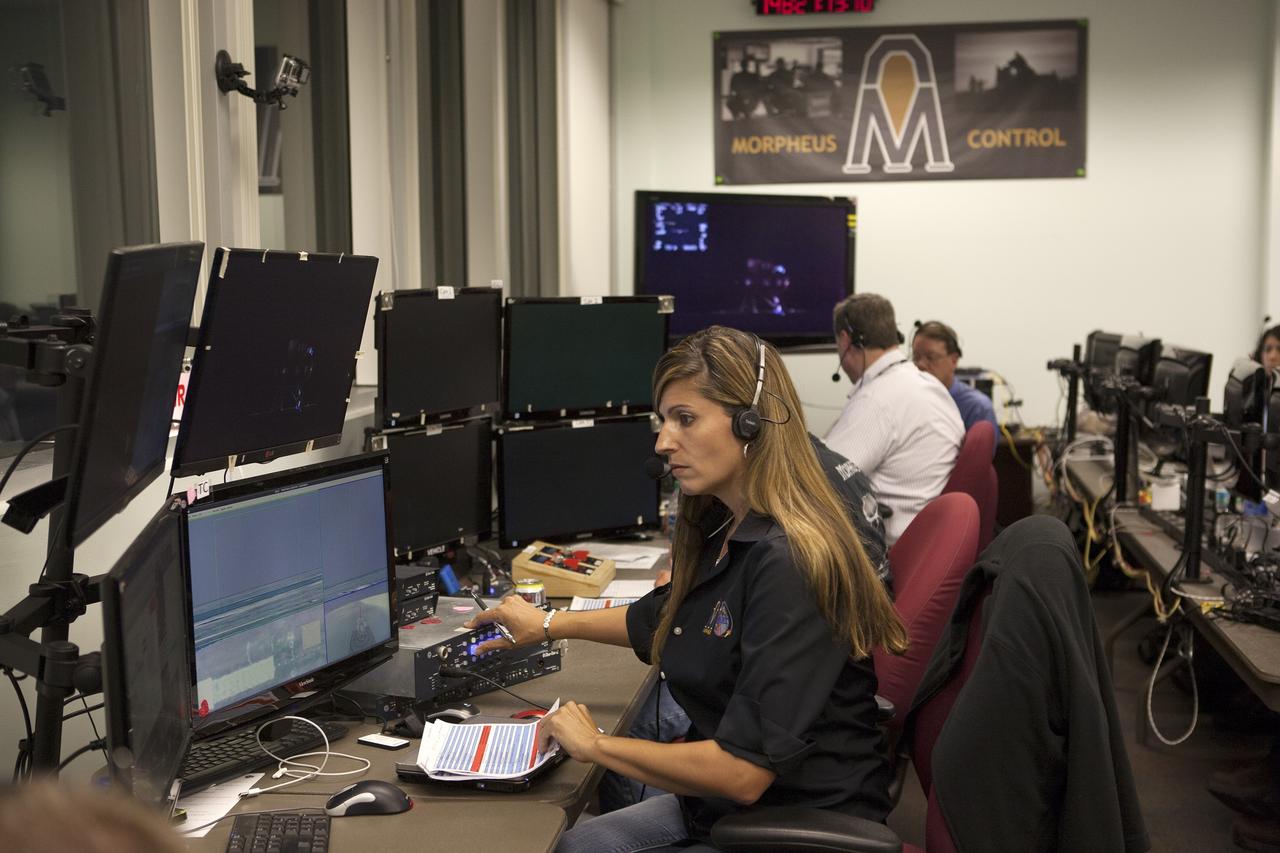 CAPE CANAVERAL, Fla. -- Engineers in the Morpheus Control Room monitor conditions in preparation for the first free flight test at night of NASA's Project Morpheus prototype lander from a launch pad at the north end of the Shuttle Landing Facility at NASA's Kennedy Space Center in Florida. The 98-second test began at 10:02 p.m. EDT with the Morpheus lander launching from the ground over a flame trench and ascending more than 800 feet. The vehicle, with its autonomous landing and hazard avoidance technology, or ALHAT sensors, surveyed the hazard field to determine safe landing sites. Morpheus then flew forward and downward covering approximately 1,300 feet while performing a 78-foot divert to simulate a hazard avoidance maneuver. The lander then descended and landed on a dedicated pad inside the test field. Project Morpheus tests NASA’s ALHAT and an engine that runs on liquid oxygen and methane, which are green propellants. These new capabilities could be used in future efforts to deliver cargo to planetary surfaces. The landing facility provides the lander with the kind of field necessary for realistic testing, complete with rocks, craters and hazards to avoid. Morpheus’ ALHAT payload allows it to navigate to clear landing sites amidst rocks, craters and other hazards during its descent. Project Morpheus is being managed under the Advanced Exploration Systems, or AES, Division in NASA’s Human Exploration and Operations Mission Directorate. The efforts in AES pioneer new approaches for rapidly developing prototype systems, demonstrating key capabilities and validating operational concepts for future human missions beyond Earth orbit. For more information on Project Morpheus, visit http://morpheuslander.jsc.nasa.gov/. Photo credit: NASA/Kim Shiflett