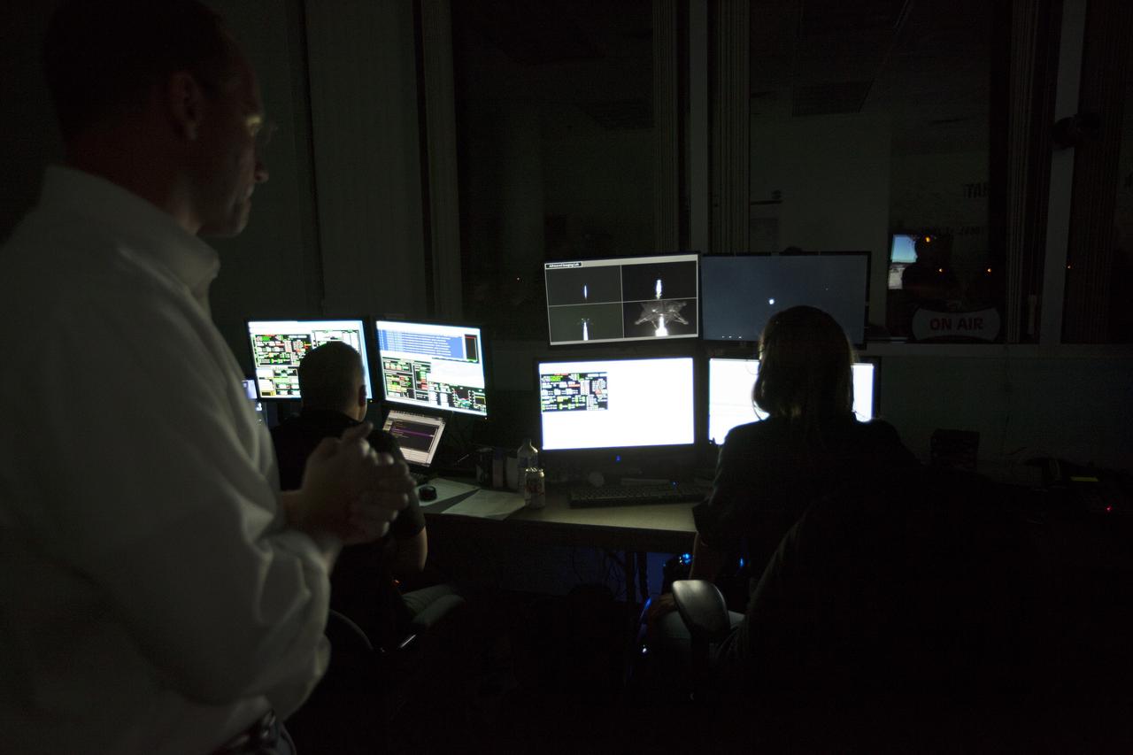 CAPE CANAVERAL, Fla. -- Engineers in the Morpheus Control Room monitor NASA's Project Morpheus prototype lander as it lifts off on the first free flight test at night from a launch pad at the north end of the Shuttle Landing Facility at NASA's Kennedy Space Center in Florida. The 98-second test began at 10:02 p.m. EDT with the Morpheus lander launching from the ground over a flame trench and ascending more than 800 feet. The vehicle, with its autonomous landing and hazard avoidance technology, or ALHAT sensors, surveyed the hazard field to determine safe landing sites. Morpheus then flew forward and downward covering approximately 1,300 feet while performing a 78-foot divert to simulate a hazard avoidance maneuver. The lander then descended and landed on a dedicated pad inside the test field. Project Morpheus tests NASA’s ALHAT and an engine that runs on liquid oxygen and methane, which are green propellants. These new capabilities could be used in future efforts to deliver cargo to planetary surfaces. The landing facility provides the lander with the kind of field necessary for realistic testing, complete with rocks, craters and hazards to avoid. Morpheus’ ALHAT payload allows it to navigate to clear landing sites amidst rocks, craters and other hazards during its descent. Project Morpheus is being managed under the Advanced Exploration Systems, or AES, Division in NASA’s Human Exploration and Operations Mission Directorate. The efforts in AES pioneer new approaches for rapidly developing prototype systems, demonstrating key capabilities and validating operational concepts for future human missions beyond Earth orbit. For more information on Project Morpheus, visit http://morpheuslander.jsc.nasa.gov/. Photo credit: NASA/Kim Shiflett