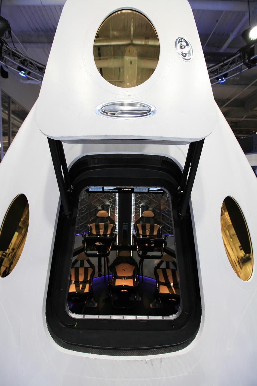 HAWTHORNE, Calif. - A look through the open hatch of the Dragon V2 reveals the layout and interior of the seven-crew capacity spacecraft. SpaceX unveiled the new spacecraft during a ceremony at its headquarters in Hawthorne, Calif. The Dragon V2 is designed to carry people into Earth's orbit and was developed in partnership with NASA's Commercial Crew Program under the Commercial Crew Integrated Capability agreement. SpaceX is one of NASA's commercial partners working to develop a new generation of U.S. spacecraft and rockets capable of transporting humans to and from Earth's orbit from American soil. Ultimately, NASA intends to use such commercial systems to fly U.S. astronauts to and from the International Space Station. Photo credit: NASA/Dimitri Gerondidakis