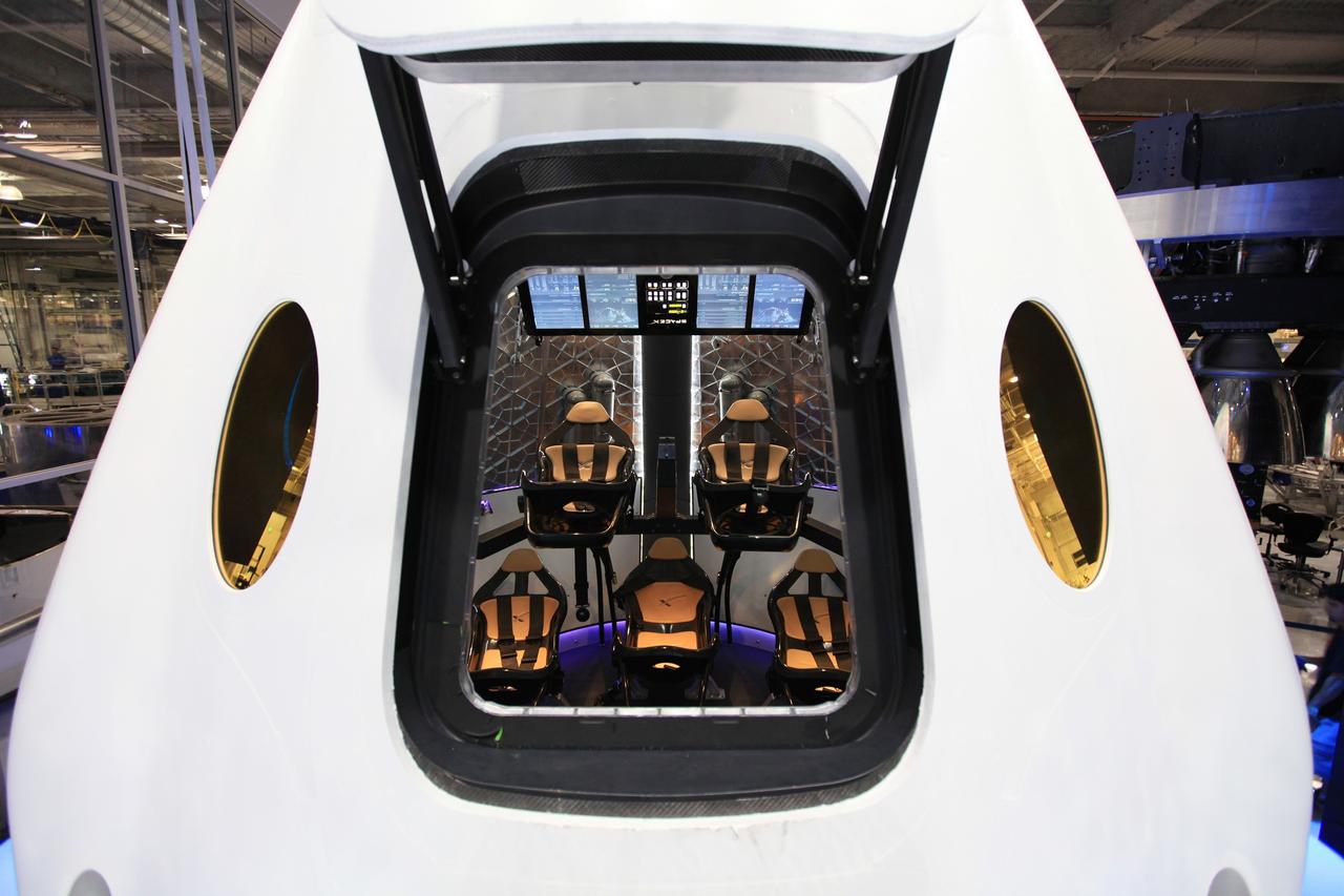 HAWTHORNE, Calif. - A look through the open hatch of the Dragon V2 reveals the layout and interior of the seven-crew capacity spacecraft. SpaceX unveiled the new spacecraft during a ceremony at its headquarters in Hawthorne, Calif. The Dragon V2 is designed to carry people into Earth's orbit and was developed in partnership with NASA's Commercial Crew Program under the Commercial Crew Integrated Capability agreement. SpaceX is one of NASA's commercial partners working to develop a new generation of U.S. spacecraft and rockets capable of transporting humans to and from Earth's orbit from American soil. Ultimately, NASA intends to use such commercial systems to fly U.S. astronauts to and from the International Space Station. Photo credit: NASA/Dimitri Gerondidakis