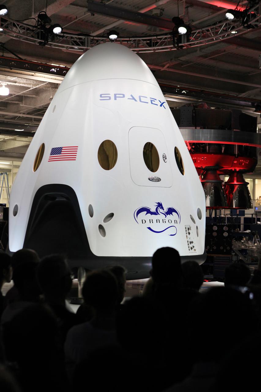 HAWTHORNE, Calif. - HAWTHORNE, Calif. - The Dragon V2 stands on a stage inside SpaceX headquarters in Hawthorne, Calif., during its unveiling ceremony. The spacecraft is designed to carry people into Earth's orbit and was developed in partnership with NASA's Commercial Crew Program under the Commercial Crew Integrated Capability agreement. SpaceX is one of NASA's commercial partners working to develop a new generation of U.S. spacecraft and rockets capable of transporting humans to and from Earth's orbit from American soil. Ultimately, NASA intends to use such commercial systems to fly U.S. astronauts to and from the International Space Station. Photo credit: NASA/Dimitri Gerondidakis