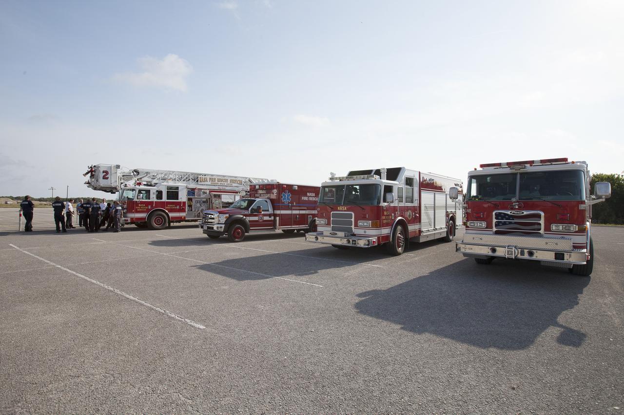 CAPE CANAVERAL, Fla. -- At NASA's Kennedy Space Center in Florida, Fire Rescue vehicles line up in a parking area near the Vehicle Assembly Building for training with pilots in NASA Aircraft Operations. The exercise is designed to develop procedures for using agency helicopters to transport injured patients to a local hospital.    The activity taking place in Kennedy's Launch Complex 39 turn-basin parking lot was only one of several drills. It was part of a new training program that was developed by Kennedy's Fire Rescue department along with NASA Aircraft Operations to sharpen the skills needed to help rescue personnel learn how to collaborate with helicopter pilots in taking injured patients to hospitals as quickly as possible. Photo credit: NASA/Dan Casper