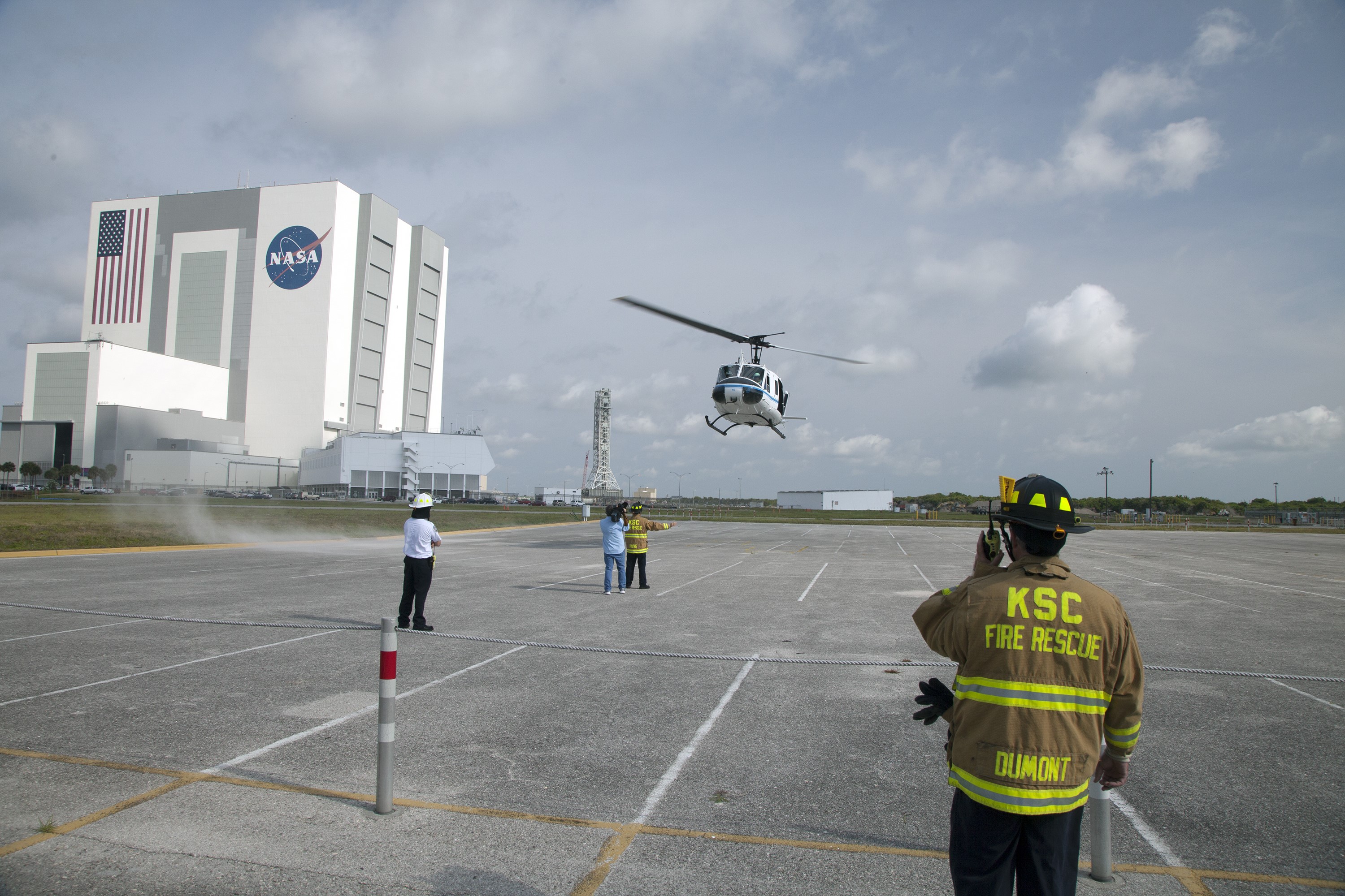 CAPE CANAVERAL, Fla. -- At NASA's Kennedy Space Center in Florida, agency Fire Rescue personnel direct an agency helicopter in for a landing during a training exercise.      The activity taking place in Kennedy's Launch Complex 39 turn-basin parking lot was only one of several drills. It was part of a new training program that was developed by Kennedy's Fire Rescue department along with NASA Aircraft Operations to sharpen the skills needed to help rescue personnel learn how to collaborate with helicopter pilots in taking injured patients to hospitals as quickly as possible. Photo credit: NASA/Dan Casper
