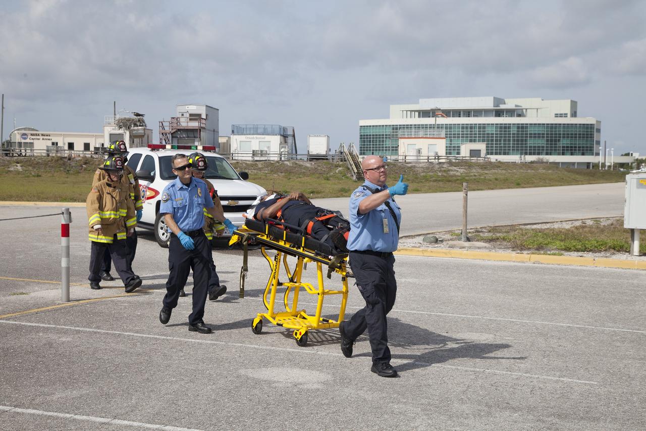 CAPE CANAVERAL, Fla. -- At NASA's Kennedy Space Center in Florida, paramedics and Fire Rescue personnel move a stretcher to the waiting helicopter as they work quickly to have the patient ready to transport after he was removed from a vehicle.      The activity taking place in Kennedy's Launch Complex 39 turn-basin parking lot was only one of several drills. It was part of a new training program that was developed by Kennedy's Fire Rescue department along with NASA Aircraft Operations to sharpen the skills needed to help rescue personnel learn how to collaborate with helicopter pilots in taking injured patients to hospitals as quickly as possible. Photo credit: NASA/Dan Casper