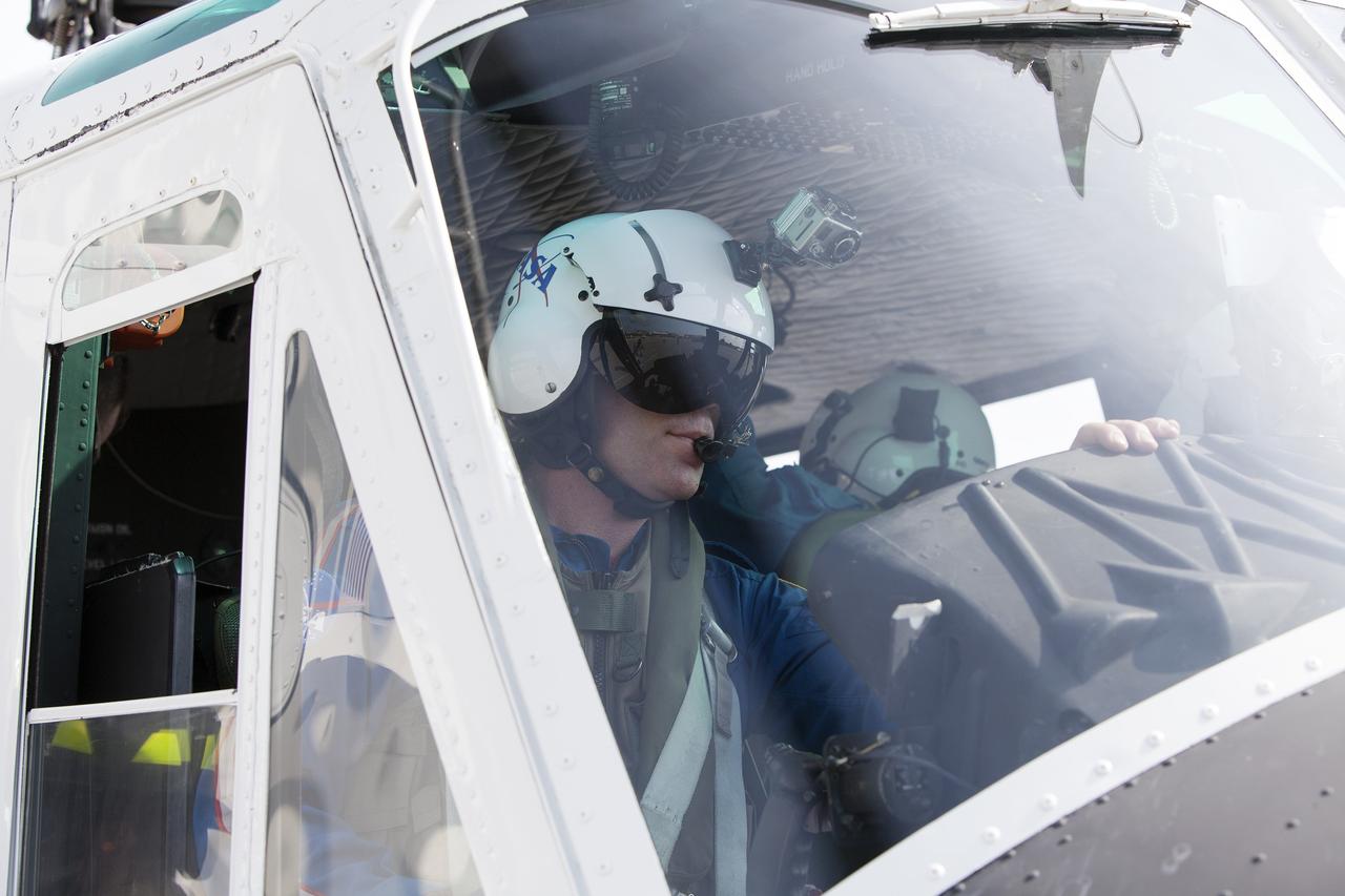 CAPE CANAVERAL, Fla. -- At NASA's Kennedy Space Center in Florida, helicopter pilot Bill Martin, a URS Federal Technical Services in the agency's Aircraft Operations, ensures all is clear before taking off during a training exercise.      The activity taking place in Kennedy's Launch Complex 39 turn-basin parking lot was only one of several drills. It was part of a new training program that was developed by Kennedy's Fire Rescue department along with NASA Aircraft Operations to sharpen the skills needed to help rescue personnel learn how to collaborate with helicopter pilots in taking injured patients to hospitals as quickly as possible. Photo credit: NASA/Dan Casper