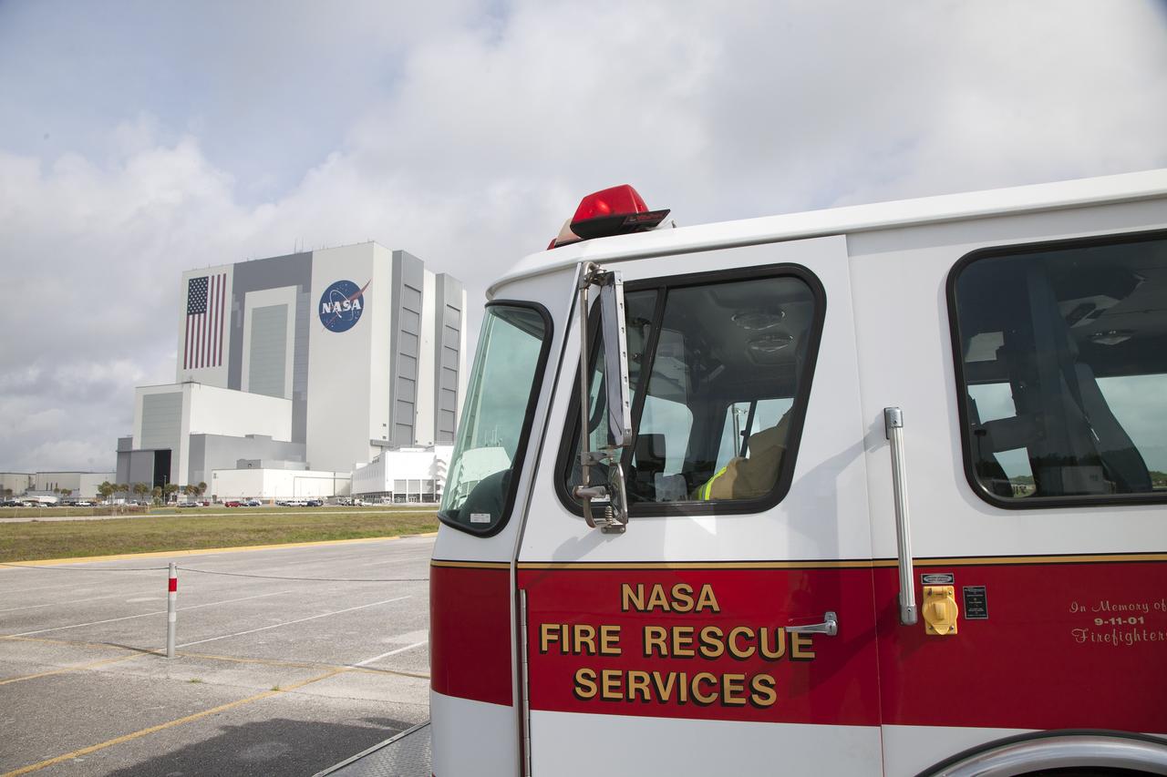 CAPE CANAVERAL, Fla. -- At NASA's Kennedy Space Center in Florida, a Fire Rescue vehicle stands by in a parking area near the Vehicle Assembly Building for training with pilots in NASA Aircraft Operations. The exercise is designed to develop procedures for using agency helicopters to transport injured patients to a local hospital.    The activity taking place in Kennedy's Launch Complex 39 turn-basin parking lot was only one of several drills. It was part of a new training program that was developed by Kennedy's Fire Rescue department along with NASA Aircraft Operations to sharpen the skills needed to help rescue personnel learn how to collaborate with helicopter pilots in taking injured patients to hospitals as quickly as possible. Photo credit: NASA/Dan Casper