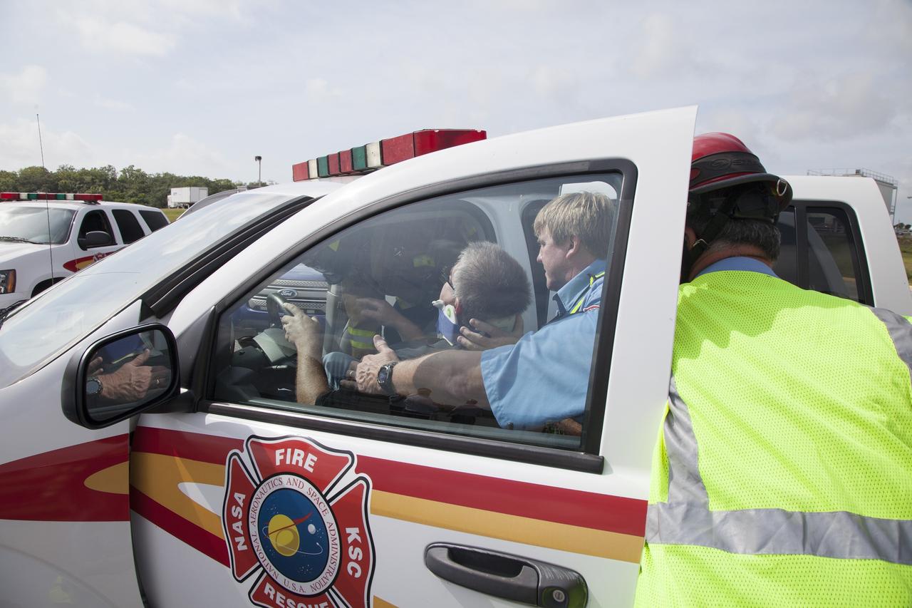 CAPE CANAVERAL, Fla. -- At NASA's Kennedy Space Center in Florida, paramedics remove George Jacobs, NASA's deputy director of Center Operations, from a vehicle simulating a rescue operation. Jacobs served as a "volunteer patient" during the activity.    The activity taking place in Kennedy's Launch Complex 39 turn-basin parking lot was only one of several drills. It was part of a new training program that was developed by Kennedy's Fire Rescue department along with NASA Aircraft Operations to sharpen the skills needed to help rescue personnel learn how to collaborate with helicopter pilots in taking injured patients to hospitals as quickly as possible. Photo credit: NASA/Dan Casper