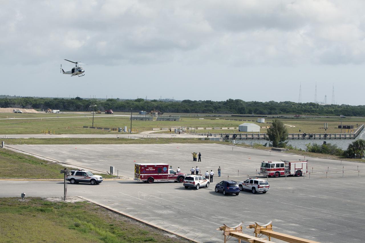 CAPE CANAVERAL, Fla. -- At NASA's Kennedy Space Center in Florida, an agency helicopter flies past the Vehicle Assembly Building prior to landing for a training exercise. The activity taking place in Kennedy's Launch Complex 39 turn-basin parking lot was only one of several drills. It was part of a new training program that was developed by Kennedy's Fire Rescue department along with NASA Aircraft Operations to sharpen the skills needed to help rescue personnel learn how to collaborate with helicopter pilots in taking injured patients to hospitals as quickly as possible. Photo credit: NASA/Dan Casper