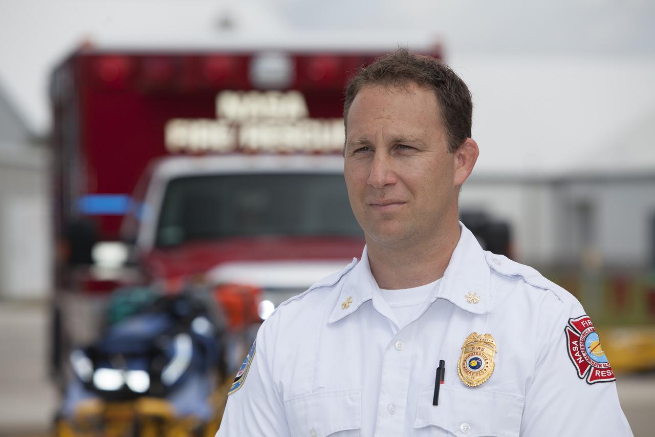 CAPE CANAVERAL, Fla. -- At NASA's Kennedy Space Center in Florida, Mark Huetter, assistant chief of Training for the center's Fire Rescue Department, is interviewed near the Shuttle Landing Facility. He discussed working with pilots in NASA Aircraft Operations to develop procedures for using agency helicopters to transport injured patients to a local hospital.    The training activity took place in Kennedy's Launch Complex 39 turn-basin parking lot. It was part of a new training program developed by Kennedy's Fire Rescue department along with NASA Aircraft Operations to sharpen the skills needed to help rescue personnel learn how to collaborate with helicopter pilots in taking injured patients to hospitals as quickly as possible. Photo credit: NASA/Dimitri Gerondidakis