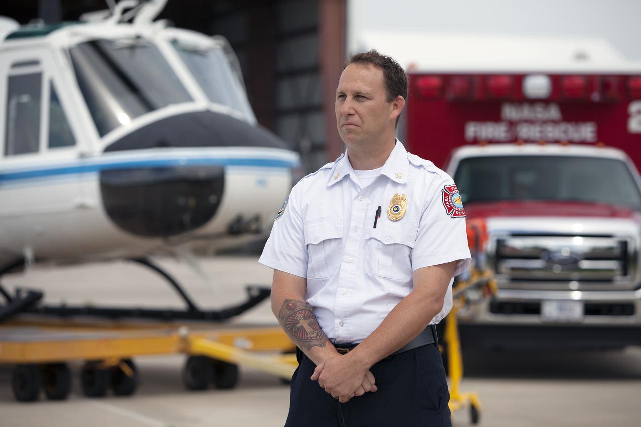 CAPE CANAVERAL, Fla. -- At NASA's Kennedy Space Center in Florida, Mark Huetter, assistant chief of Training for the center's Fire Rescue Department, is interviewed near the Shuttle Landing Facility. He discussed working with pilots in NASA Aircraft Operations to develop procedures for using agency helicopters to transport injured patients to a local hospital.    The training activity took place in Kennedy's Launch Complex 39 turn-basin parking lot. It was part of a new training program developed by Kennedy's Fire Rescue department along with NASA Aircraft Operations to sharpen the skills needed to help rescue personnel learn how to collaborate with helicopter pilots in taking injured patients to hospitals as quickly as possible. Photo credit: NASA/Dimitri Gerondidakis