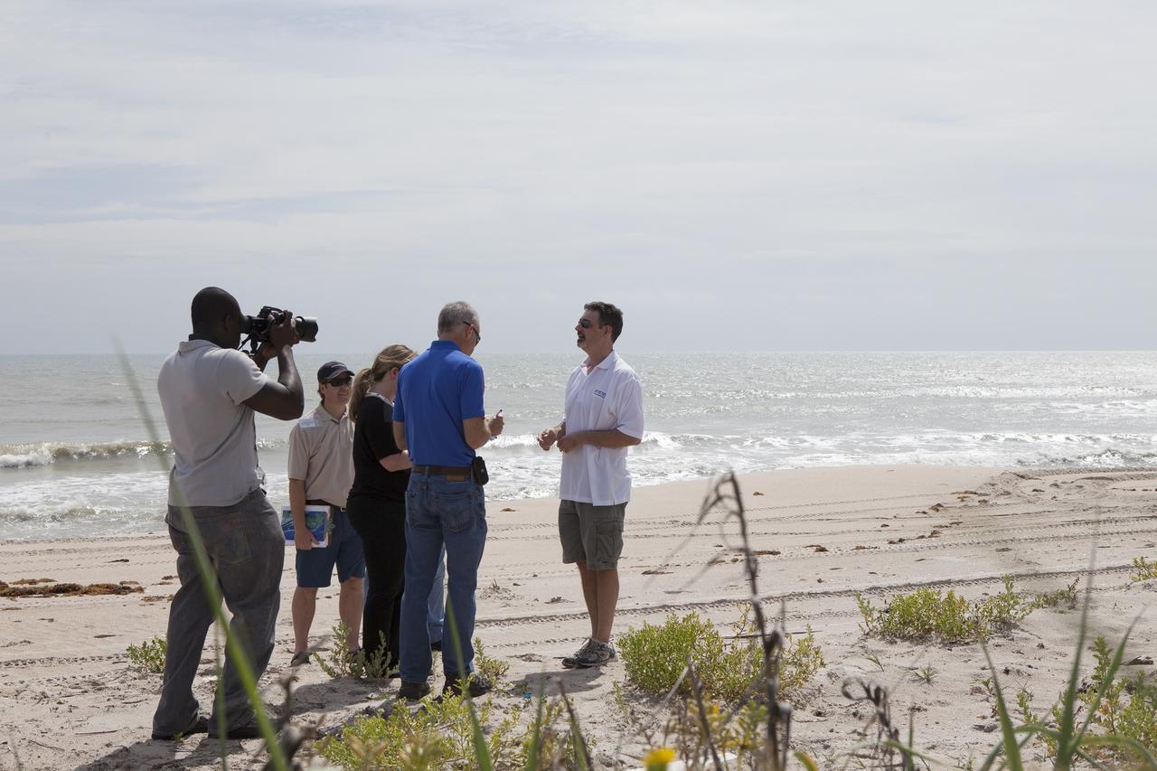 CAPE CANAVERAL, Fla. -- University of Florida geologist, John Jaeger, discusses a six-month effort to restore the sand dunes along a 1.2 mile stretch of shoreline near Launch Pads 39A and B at the Kennedy Space Center in Florida. Experts from University of Florida are working with NASA scientists to better understand beach erosion.    Constant pounding from tropical storms, such as Hurricane Sandy in October of 2012, other weather systems and higher than usual tides, destroyed sand dunes protecting infrastructure at the spaceport. Photo credit: NASA/Dan Casper