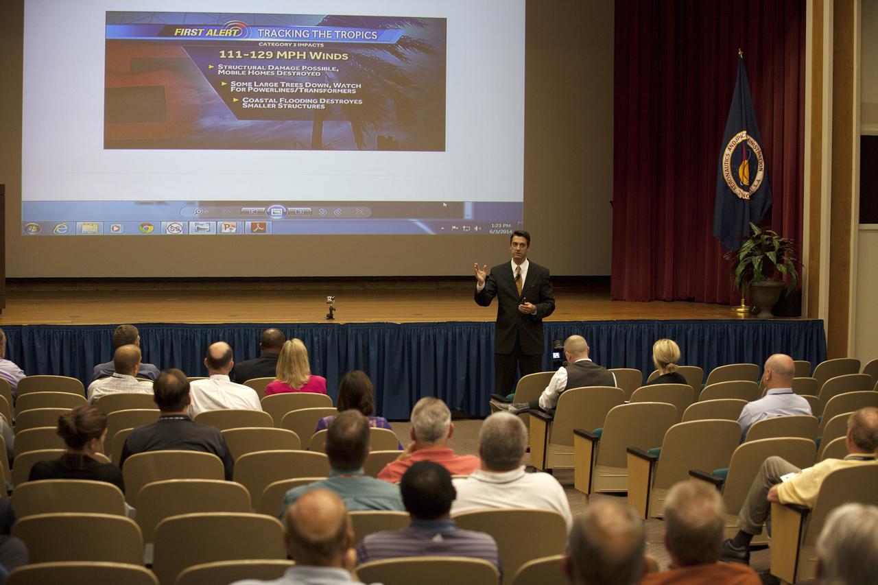 CAPE CANAVERAL, Fla. -- Tony Mainolfi, chief meteorologist of WESH 2 news, explains the categories of tropical weather disturbances to the audience of the annual hurricane awareness briefing at NASA's Kennedy Space Center in Florida.    The briefing, held at the start of the 2014 hurricane season, is attended by the center's emergency hurricane coordinators and other interested employees in the KSC Training Auditorium. The briefing also is broadcast to the workforce.  For more information, visit http://www.patrick.af.mil/weather.  Photo credit: NASA/Kim Shiflett