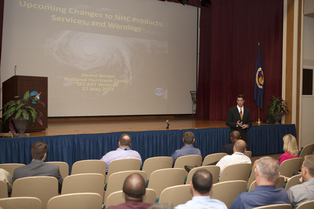 CAPE CANAVERAL, Fla. -- Tony Mainolfi, chief meteorologist of WESH 2 news, outlines the products, services and warnings provided by the National Hurricane Center for the audience of the annual hurricane awareness briefing at NASA's Kennedy Space Center in Florida.    The briefing, held at the start of the 2014 hurricane season, is attended by the center's emergency hurricane coordinators and other interested employees in the KSC Training Auditorium. The briefing also is broadcast to the workforce.  For more information, visit http://www.patrick.af.mil/weather.  Photo credit: NASA/Kim Shiflett
