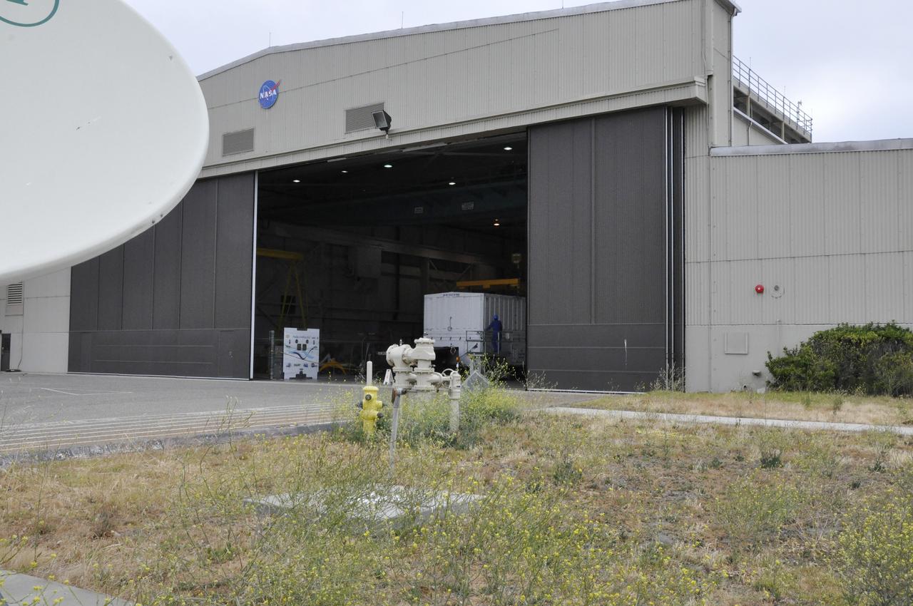 VANDENBERG AIR FORCE BASE, Calif. – The transportation trailer containing the fairing for NASA's Soil Moisture Active Passive mission, or SMAP, arrives in the Building 836 high bay on south Vandenberg Air Force Base in California. The fairing will protect the SMAP spacecraft from the heat and aerodynamic pressure generated during its ascent to orbit aboard a United Launch Alliance Delta II rocket from Space Launch Complex 2. SMAP will provide global measurements of soil moisture and its freeze/thaw state. These measurements will be used to enhance understanding of processes that link the water, energy and carbon cycles, and to extend the capabilities of weather and climate prediction models. SMAP data will also be used to quantify net carbon flux in boreal landscapes and to develop improved flood prediction and drought monitoring capabilities. Launch is scheduled for November 2014. To learn more about SMAP, visit http://smap.jpl.nasa.gov. Photo credit: NASA/Randy Beaudoin