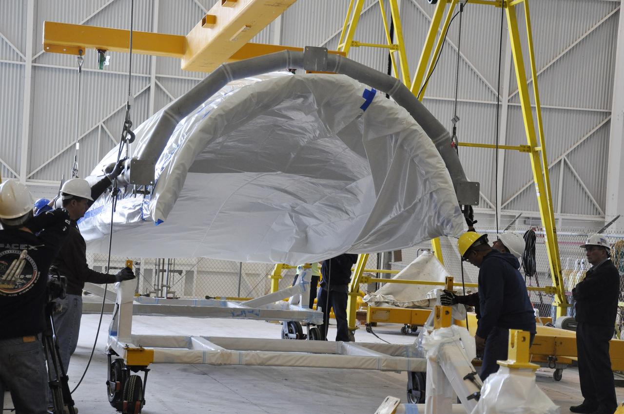 VANDENBERG AIR FORCE BASE, Calif. – A section of the fairing for NASA's Soil Moisture Active Passive mission, or SMAP, hovers above its hardware dolly in the Building 836 high bay on south Vandenberg Air Force Base in California. The fairing will protect the SMAP spacecraft from the heat and aerodynamic pressure generated during its ascent to orbit aboard a United Launch Alliance Delta II rocket from Space Launch Complex 2. SMAP will provide global measurements of soil moisture and its freeze/thaw state. These measurements will be used to enhance understanding of processes that link the water, energy and carbon cycles, and to extend the capabilities of weather and climate prediction models. SMAP data will also be used to quantify net carbon flux in boreal landscapes and to develop improved flood prediction and drought monitoring capabilities. Launch is scheduled for November 2014. To learn more about SMAP, visit http://smap.jpl.nasa.gov. Photo credit: NASA/Randy Beaudoin