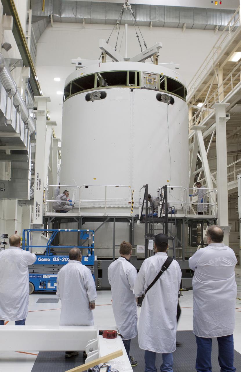 CAPE CANAVERAL, Fla. -- Inside the Operations and Checkout Building high bay at NASA's Kennedy Space Center in Florida, NASA and Lockheed Martin technicians and engineers prepare to move the Orion service module to the Final Assembly and System Testing, or FAST, cell further down the aisle. The Orion crew module will be stacked on the service module in the FAST cell and then both modules will be put through their final system tests for Exploration Flight Test-1, or EFT-1, prior to rolling out of the facility for integration with the United Launch Alliance Delta IV Heavy rocket.     Orion is the exploration spacecraft designed to carry astronauts to destinations not yet explored by humans, including an asteroid and Mars. It will have emergency abort capability, sustain the crew during space travel and provide safe re-entry from deep space return velocities. The first unpiloted test flight of Orion, EFT-1, is scheduled to launch later this year atop a Delta IV rocket from Cape Canaveral Air Force Station in Florida to an altitude of 3,600 miles above the Earth's surface. The two-orbit, four-hour flight test will help engineers evaluate the systems critical to crew safety including the heat shield, parachute system and launch abort system. For more information, visit http://www.nasa.gov/orion. Photo credit: NASA/Glenn Benson